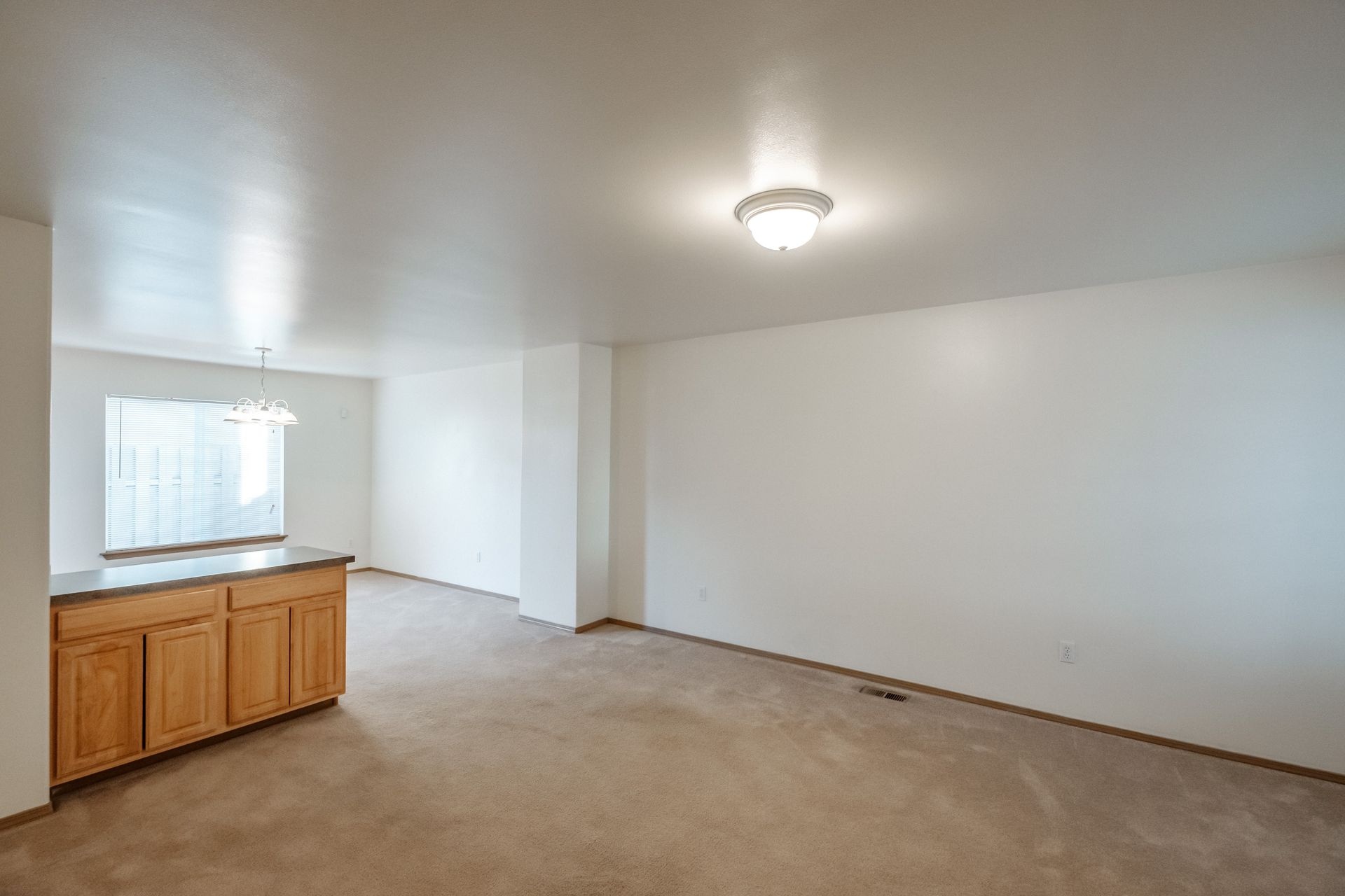 Mt. Vernon Town Homes – in Albany Oregon, two-bedroom two and ½ bathroom – living room towards dining room, and cabinetry.