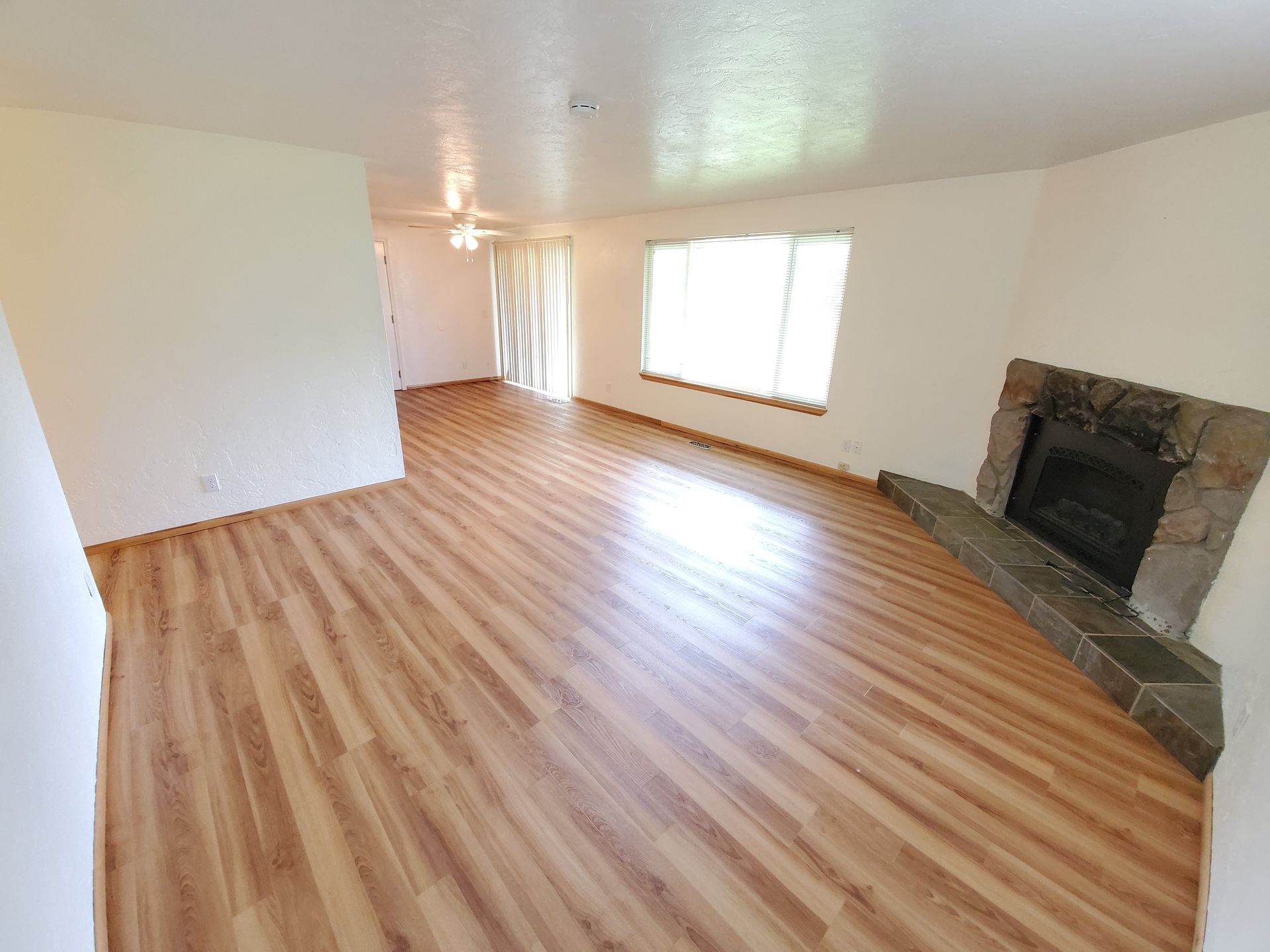 Amanda Lane Duplexes in Millersburg Oregon, three-bedroom two-bathroom – living room, fireplace, large window and wood floors