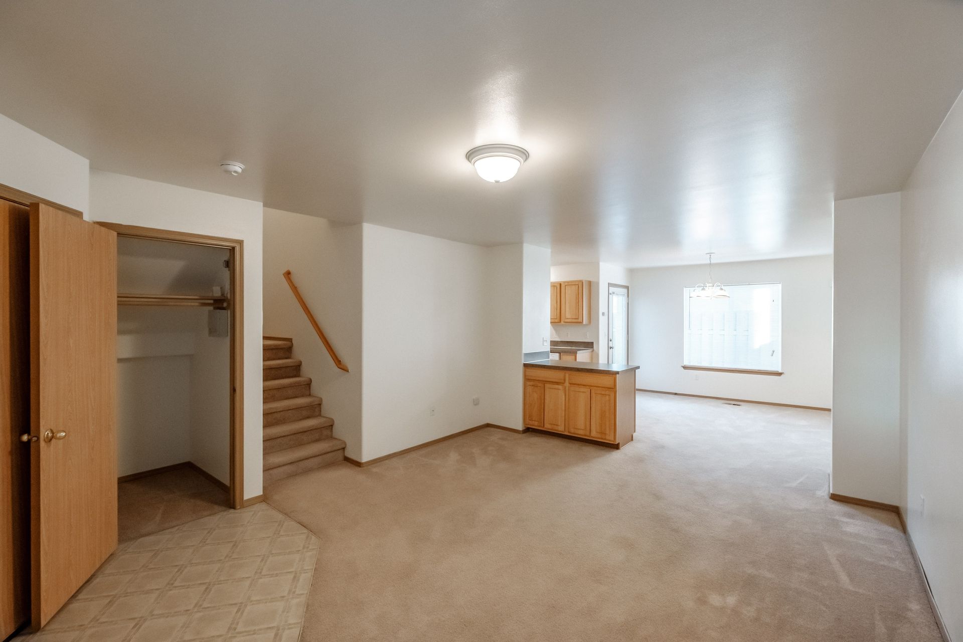 Mt. Vernon Town Homes in Albany Oregon, three-bedroom two and ½ bathroom – entryway, coat closet, staircase and living room.