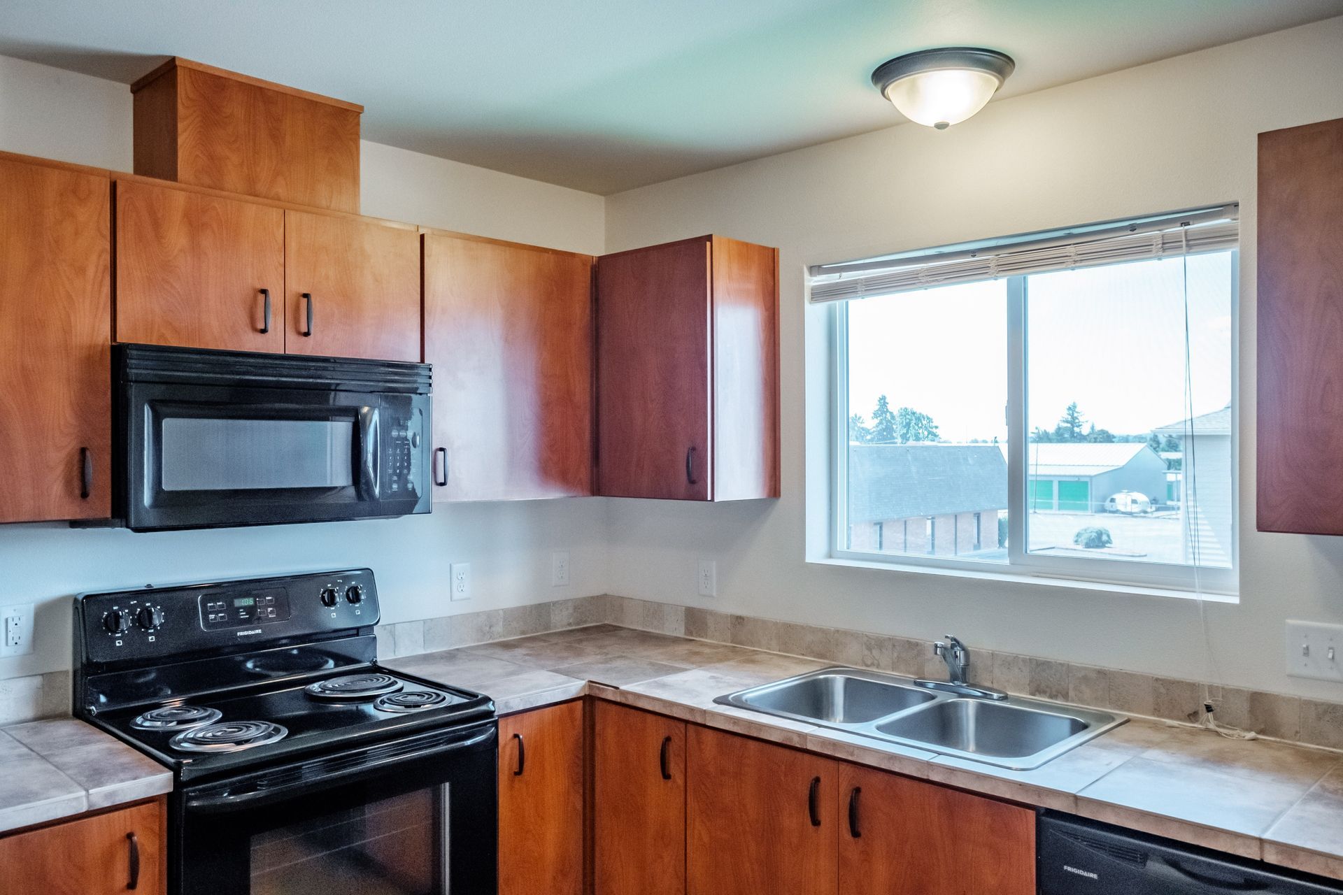Newcastle Place Apartments in Salem, OR Near Chemeketa Community College, two-bedroom two-bath– kitchen, appliances, window.