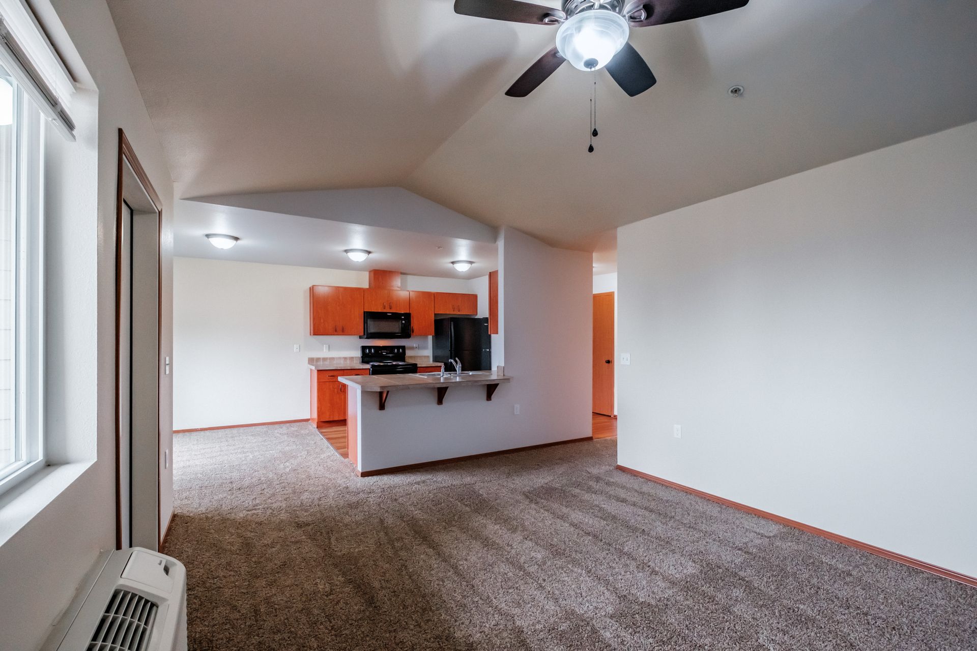 Aspen Place Apartments in Lebanon OR, near Western University of Health Sciences, two-bed two-bath – living room to kitchen.