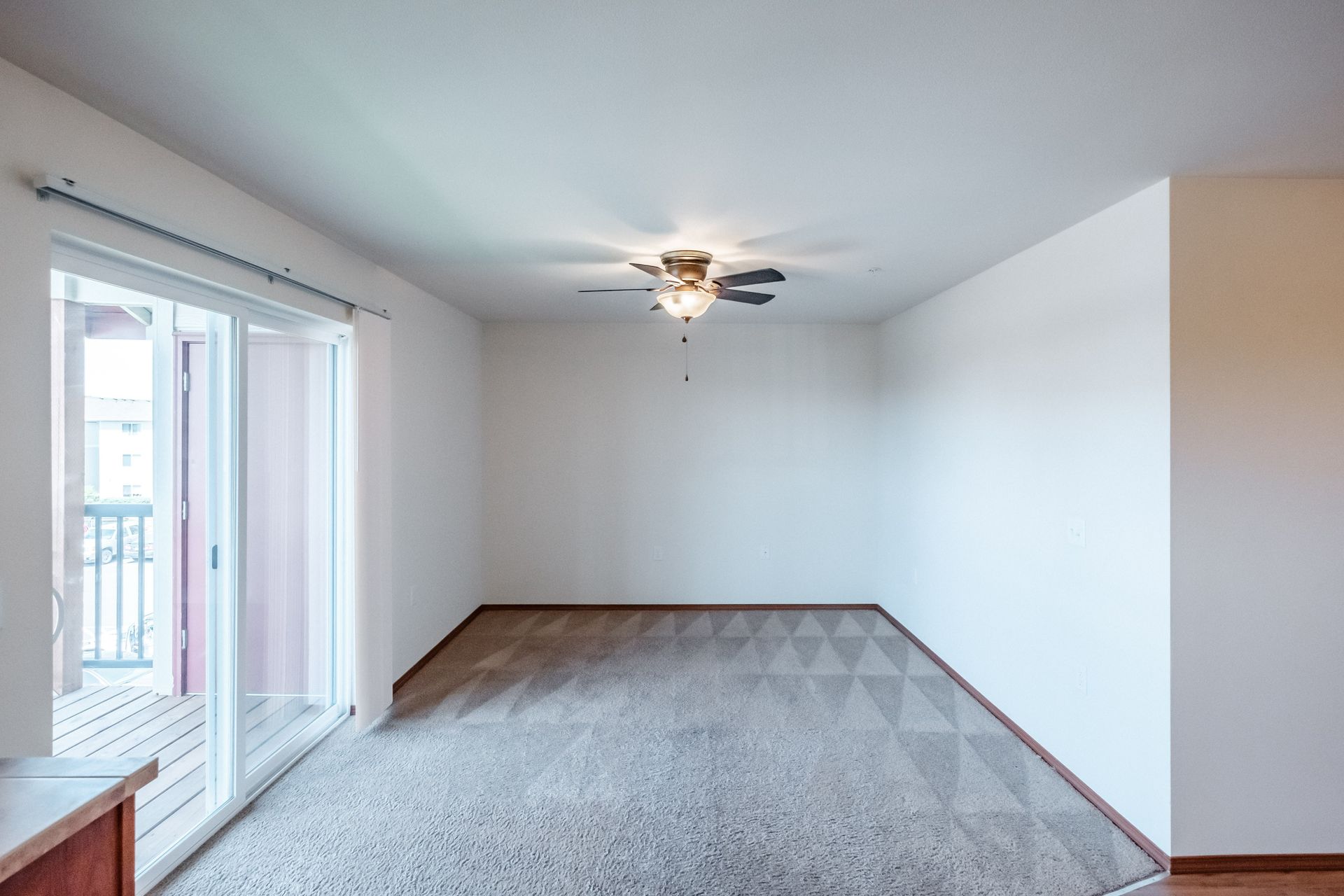 Newcastle Place Apartments in Salem, OR Near Chemeketa Community College, two-bedroom, two-bath – living room, glass door.