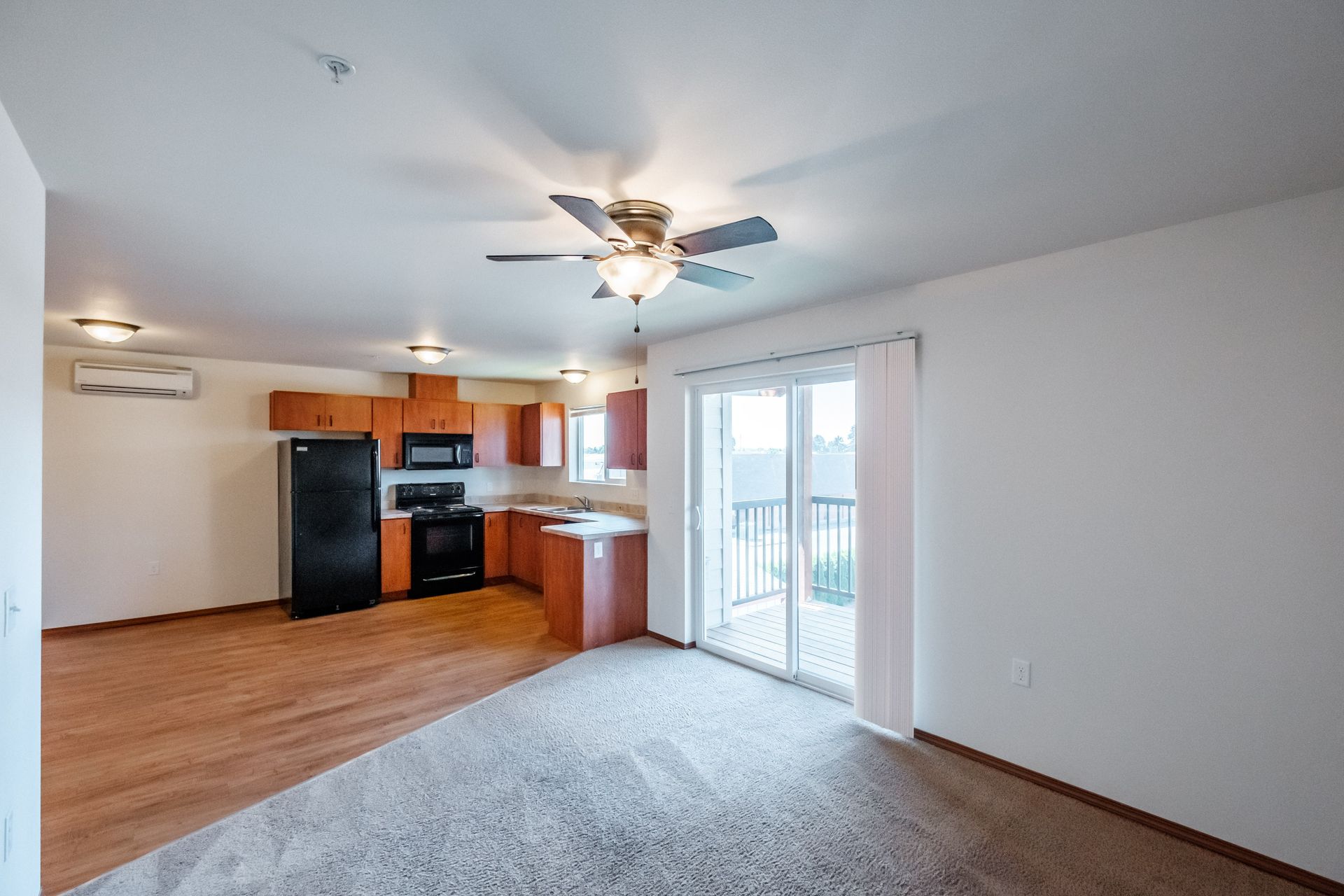 Newcastle Place Apartments in Salem, OR Near Chemeketa Community College, two-bedroom, two-bath – kitchen far, living room.