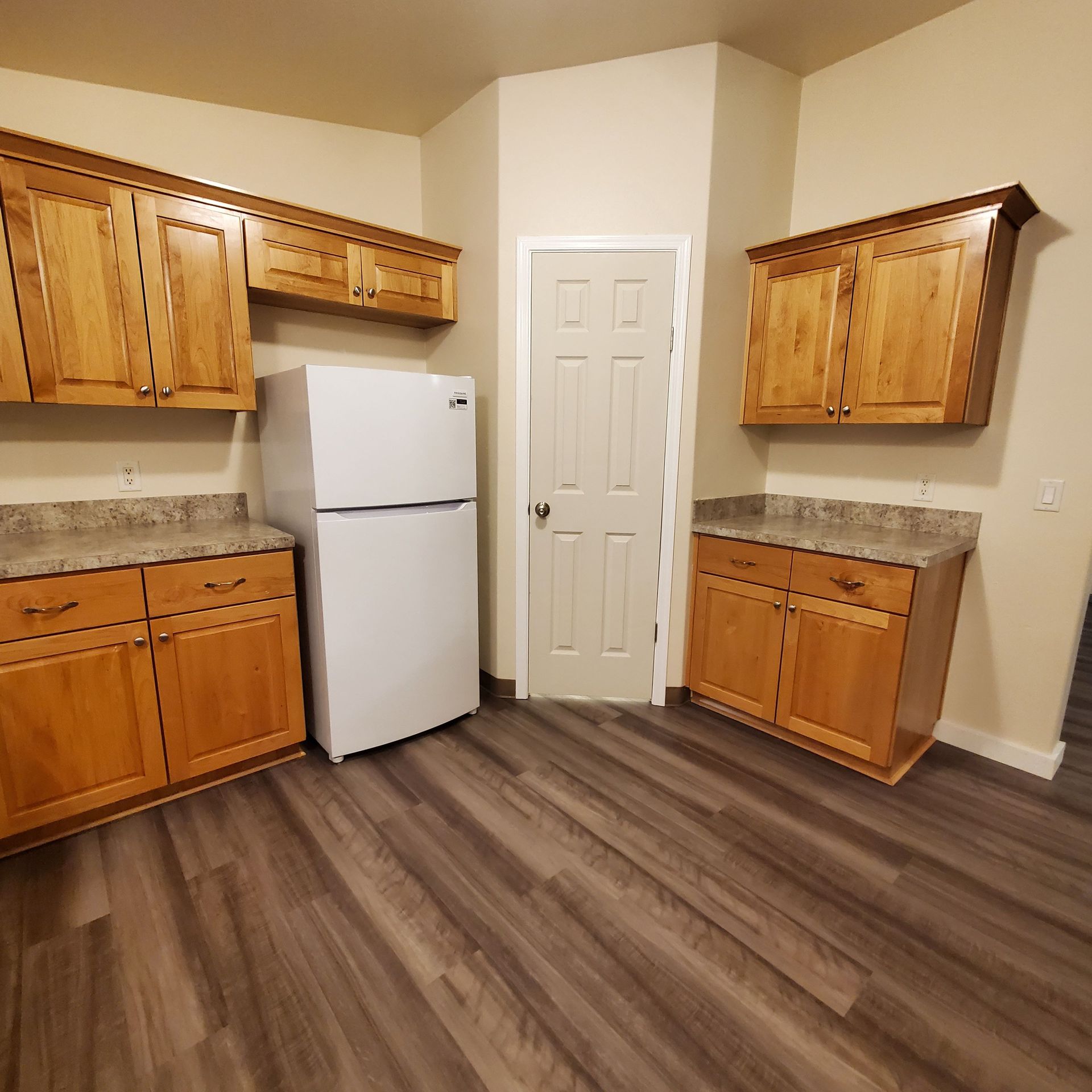 Ashwood Estates mobile homes in Tangent Oregon, four-bedroom two-bathroom – kitchen cabinets and refrigerator.