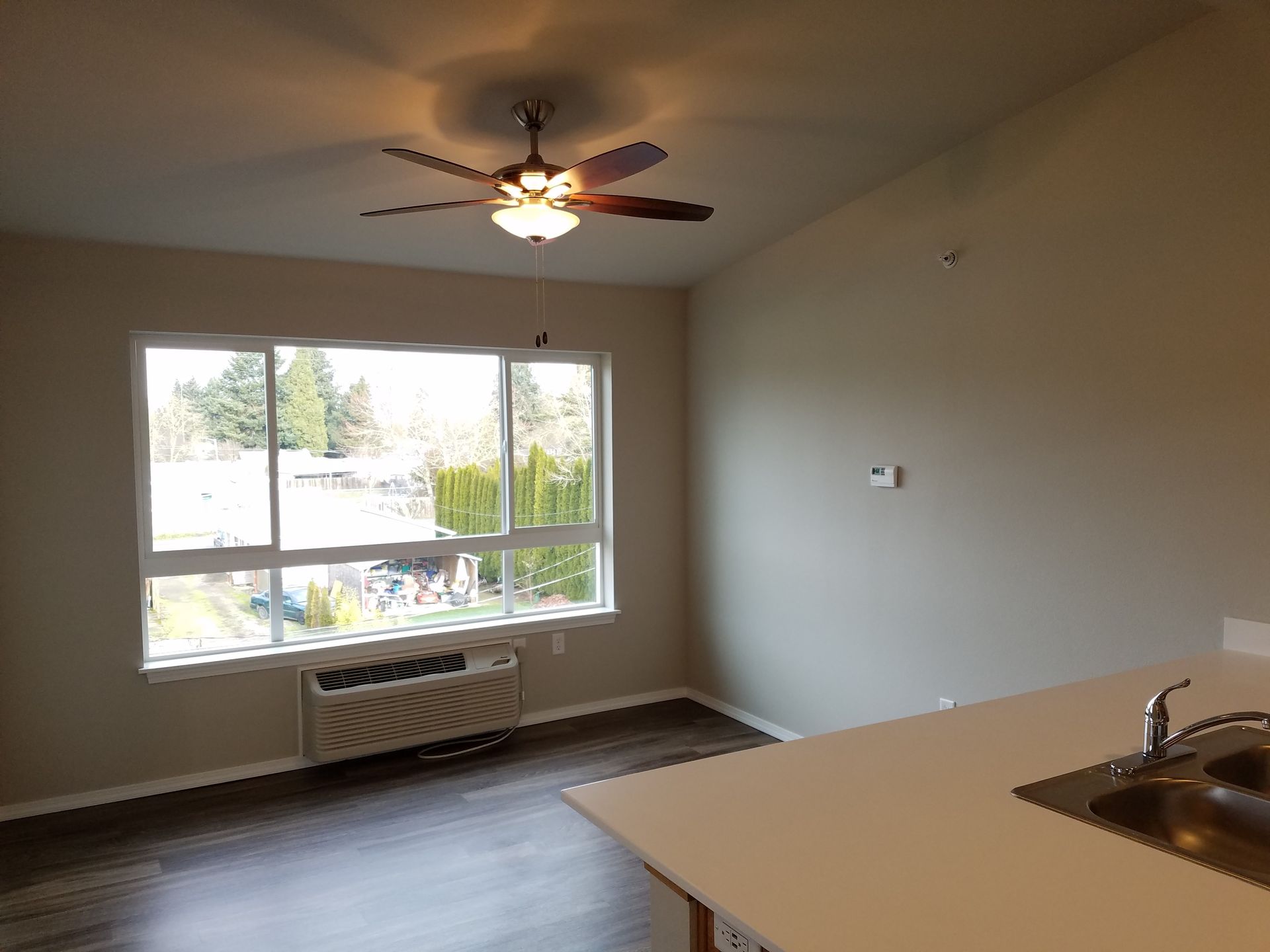 Pleasant View Apartments in Keizer Oregon, One-Bedroom one-bathroom – living room, heater, large living room window.
