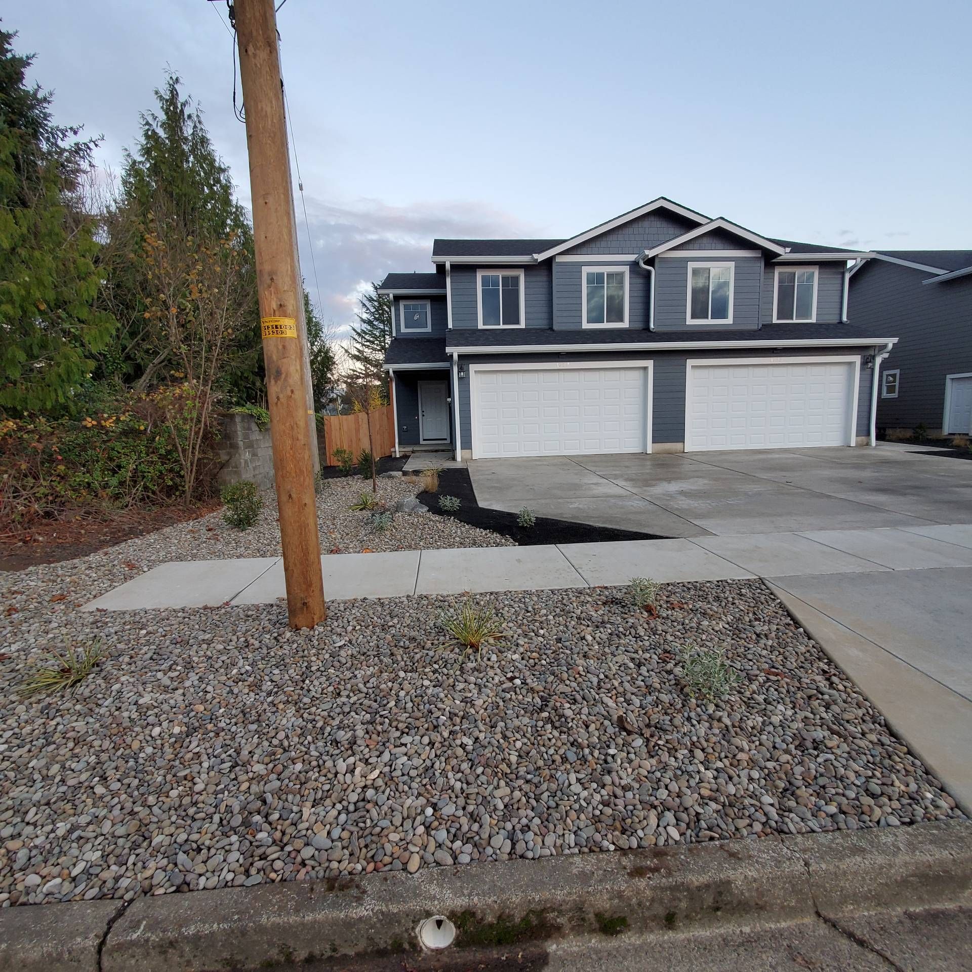 Rye Street Town Homes in Albany, OR. Two Bedroom, Two and 1/2 Bathroom – duplex front, garage doors.