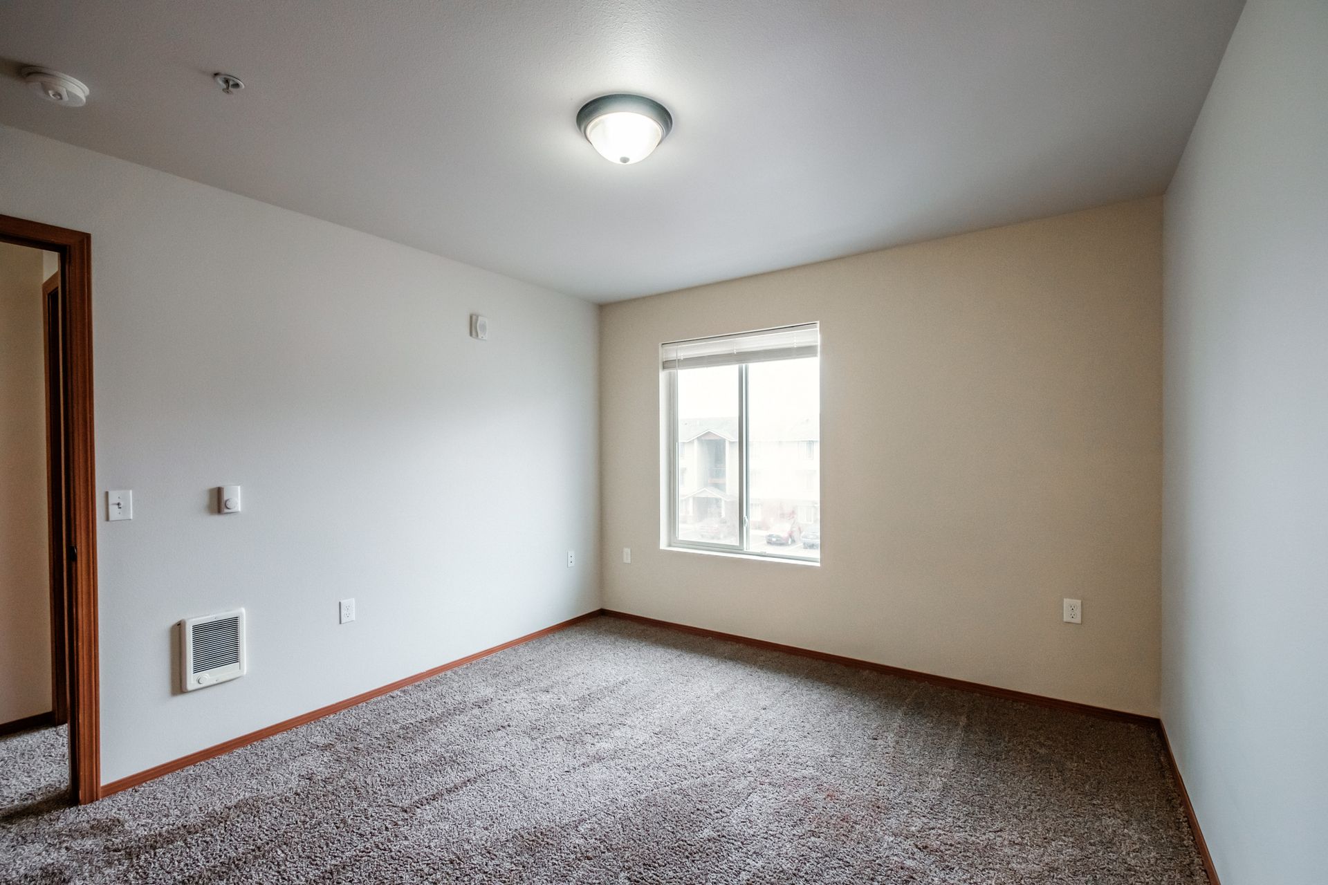 Aspen Place Apartments in Lebanon OR, near Western University of Health Sciences, two-bed two-bath –bedroom window, door -1.