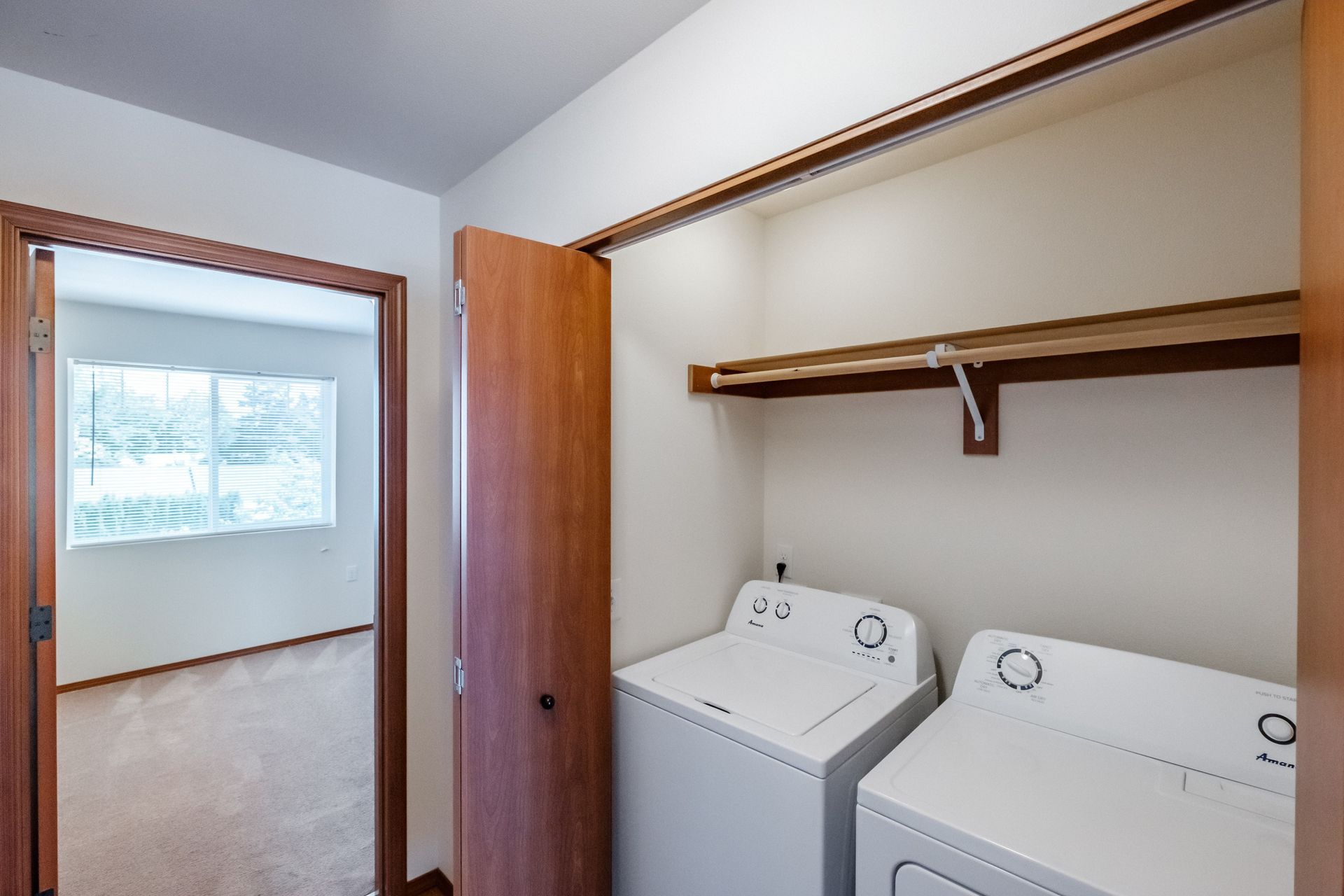 Newcastle Place Apartments in Salem, OR Near Chemeketa Community College, two-bedroom, two-bath – washer, dryer bedroom door.