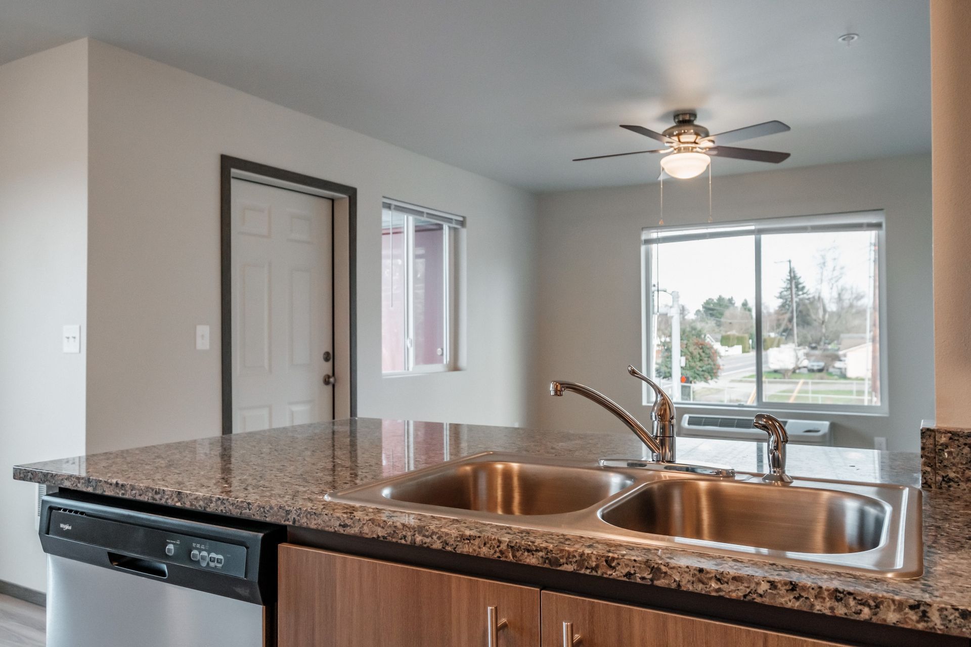 Cherry Glen Apartments in Salem Oregon – two-bedroom two-bathroom apartment home living room and kitchen sink.