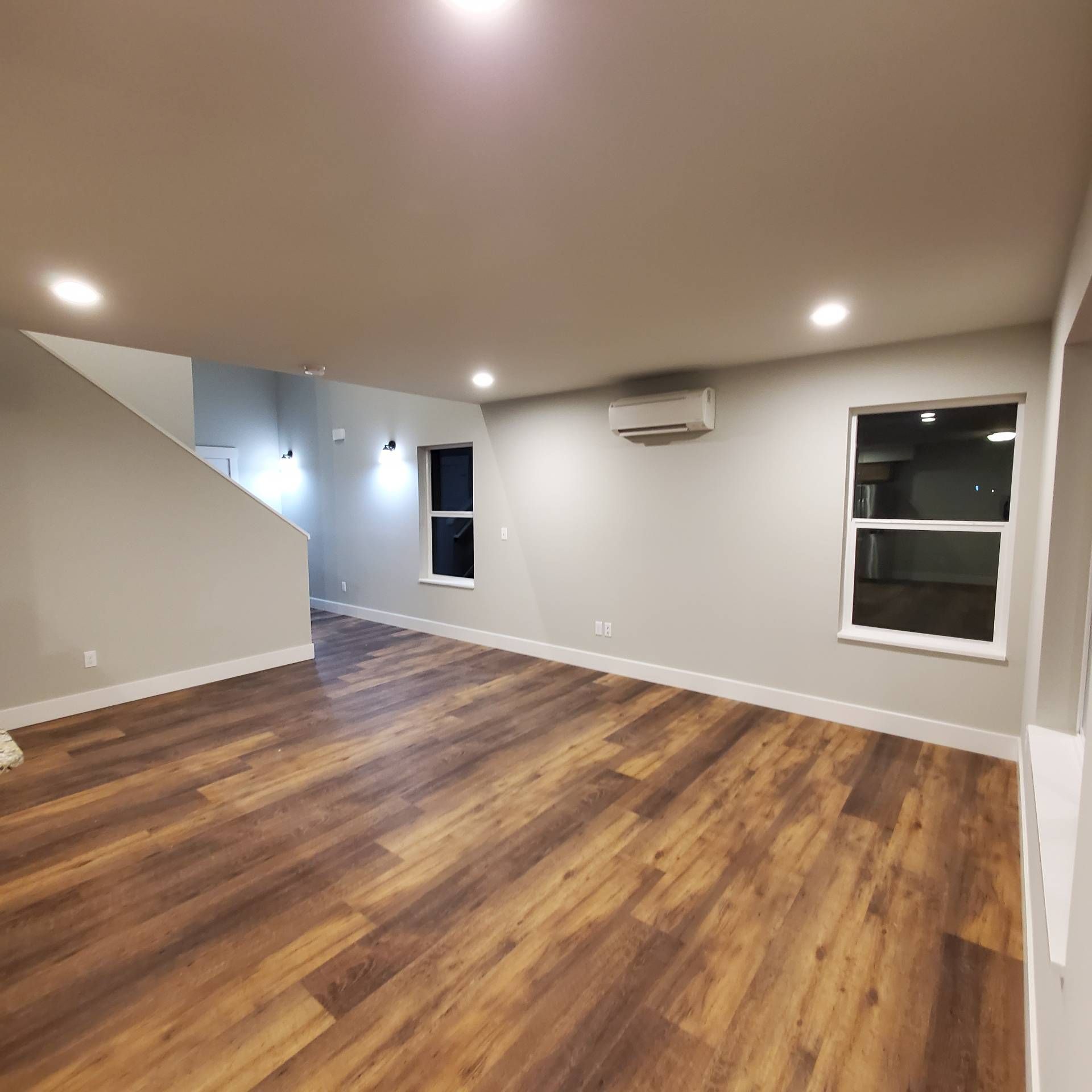 Rye Street Town Homes in Albany, OR. Two Bedroom, Two and 1/2 Bathroom – living room looking towards 2 windows and hallway.