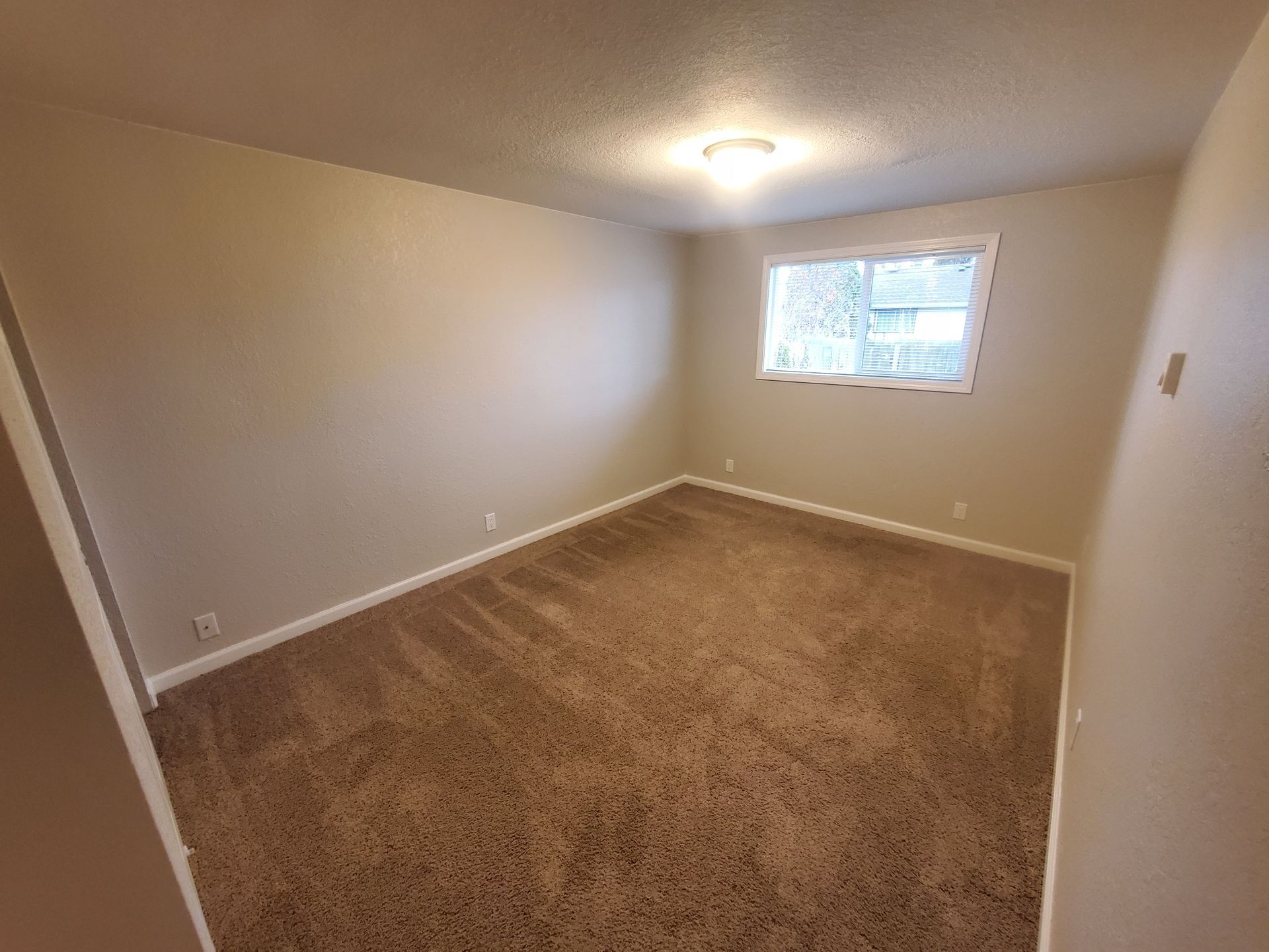 Jackson Duplexes in Albany Oregon – two bedroom one-bathroom – bedroom and window – 1. 