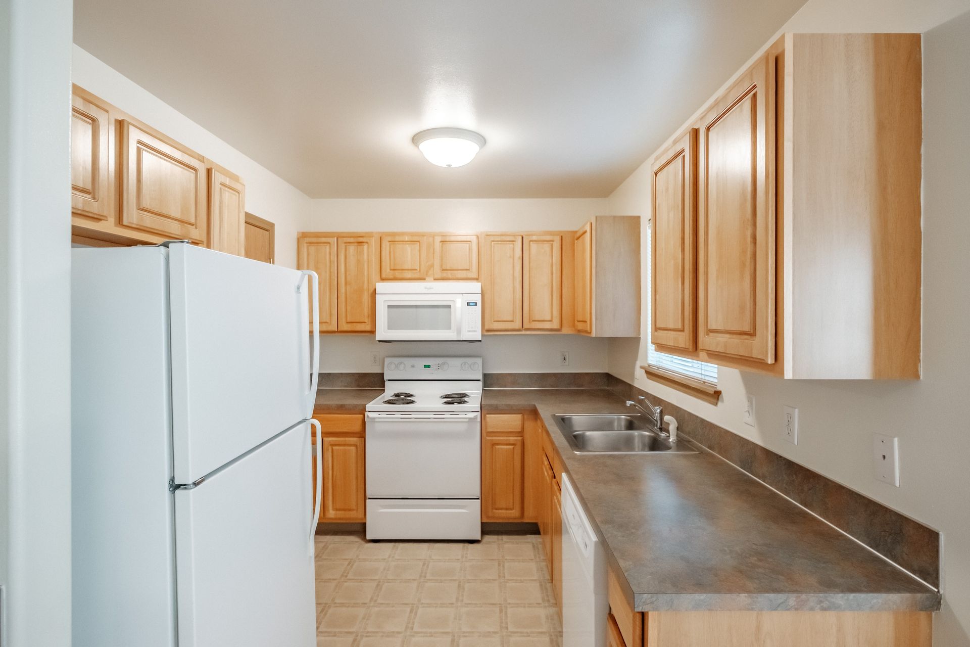 Mt. Vernon Town Homes – in Albany Oregon, two-bedroom two and ½ bathroom – kitchen, stove, microwave, refrigerator, sink.