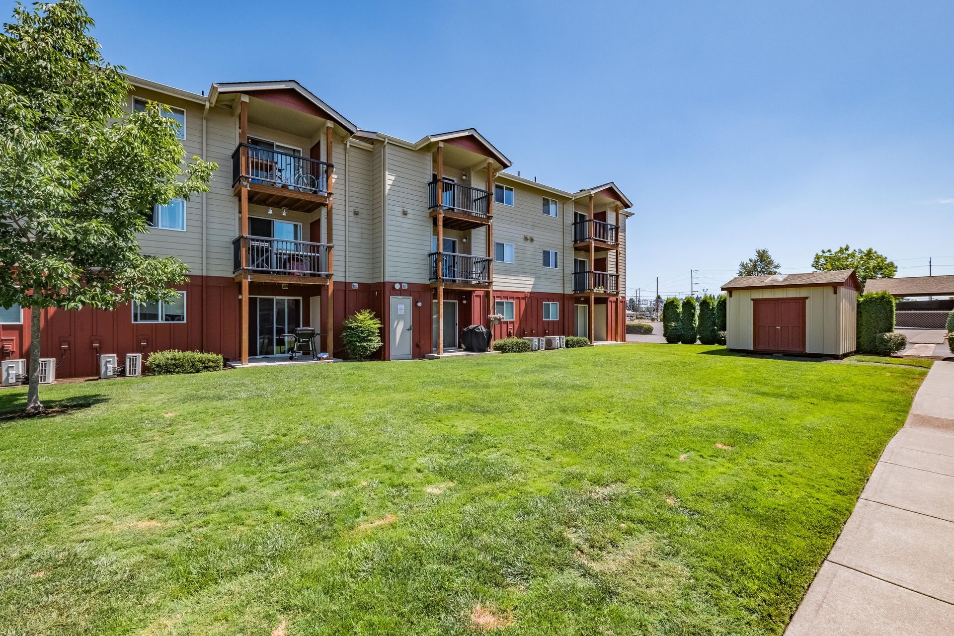 Newcastle Place Apartments in Salem Oregon, Near Chemeketa Community College -apartment community, grassy lawn and shed.