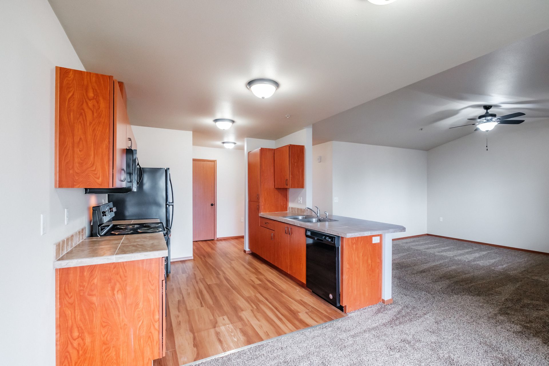 Aspen Place Apartments, near Western University of Health Sciences, two-bed two-bath – kitchen cabinetry, living room.
