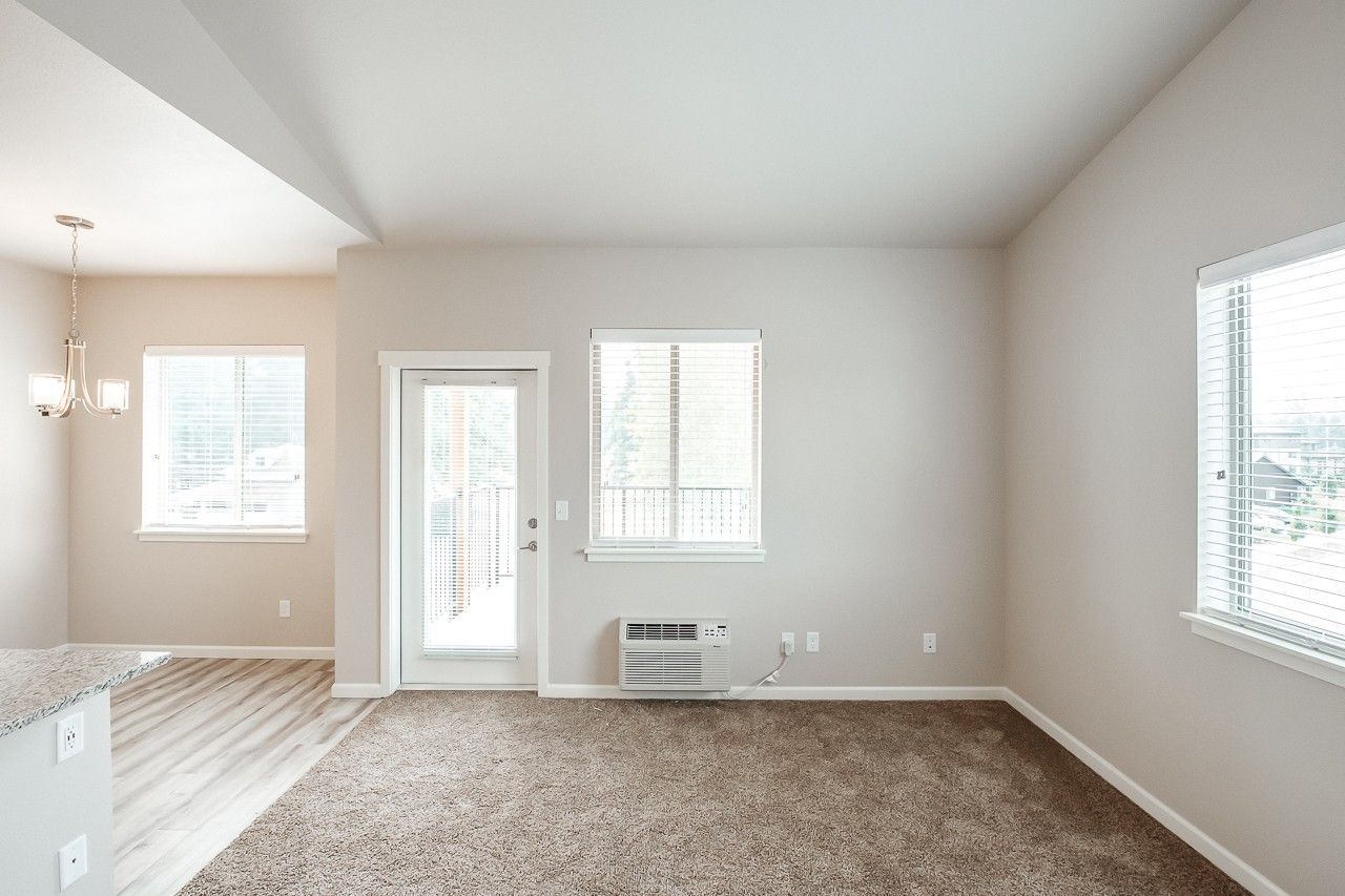 Hickory Hollow Apartments in North Albany OR, one-bedroom one-bathroom – living room, kitchen and balcony door.