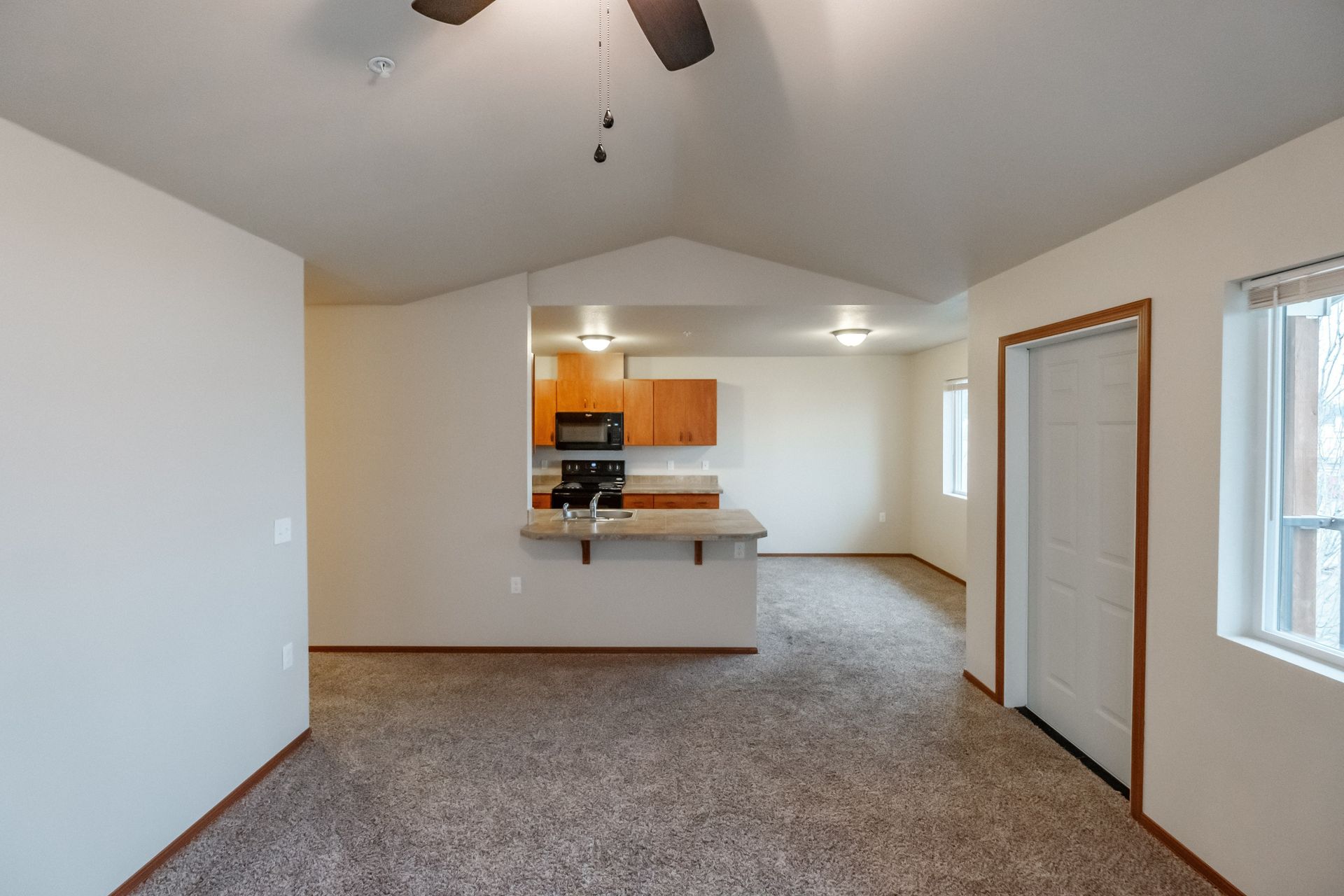 Lafayette Place Apartments in McMinnville, Oregon, near Linfield University – two-bedroom two-bath – living room to kitchen.