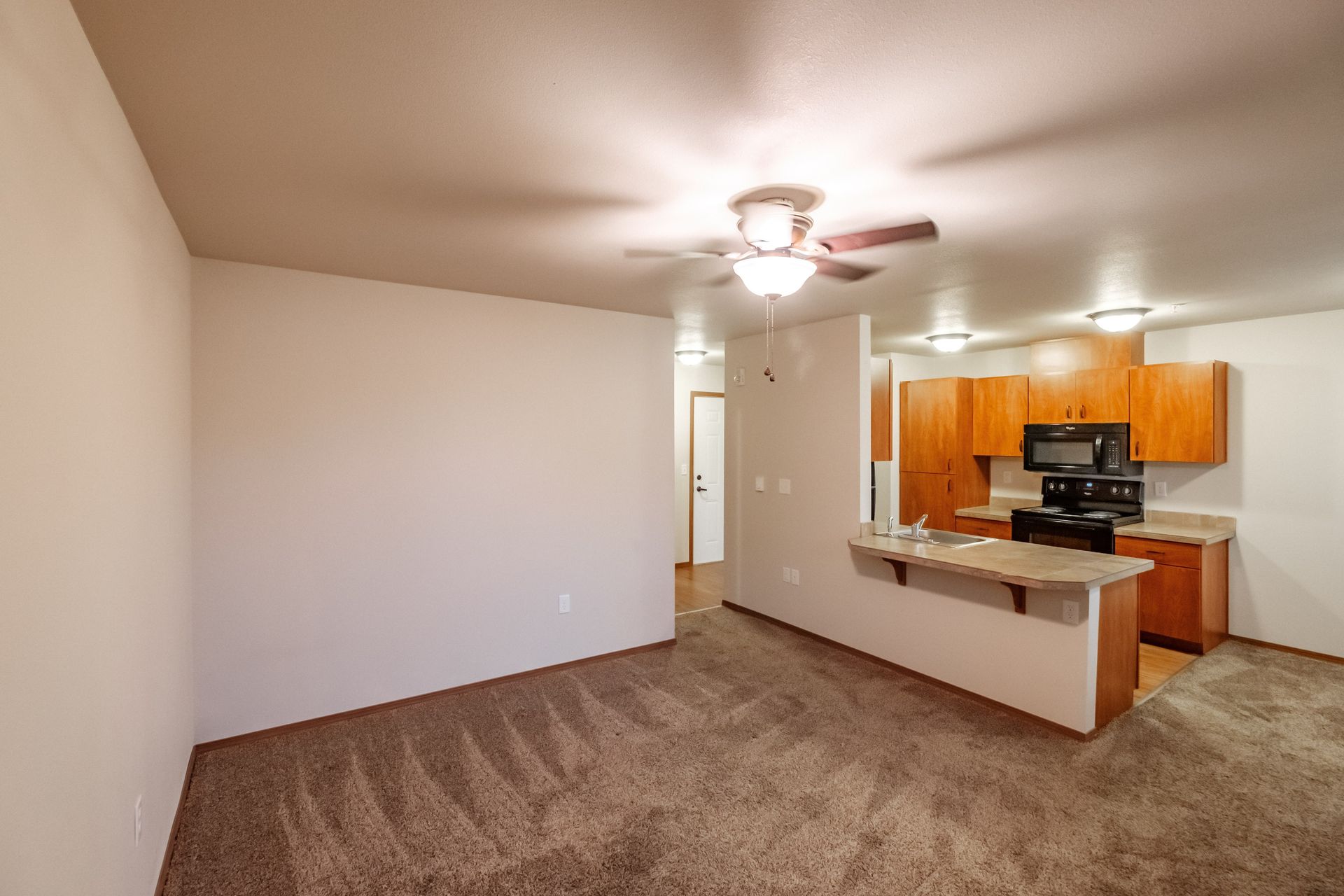 Lafayette Place Apartments in McMinnville, Oregon, near Linfield University – one-bedroom one-bath – living room to kitchen.