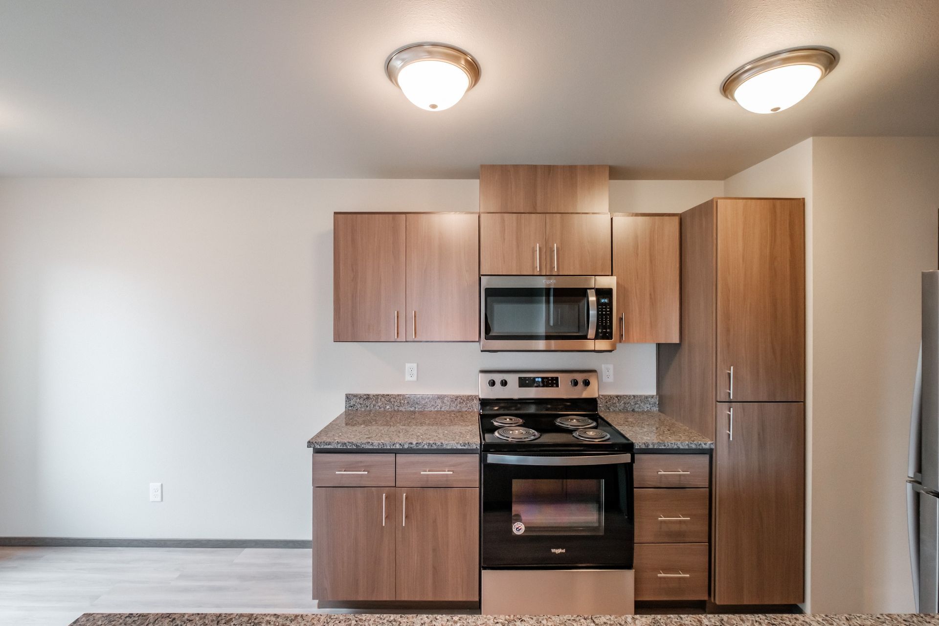 Cherry Glen Apartments in Salem Oregon – one bedroom one bathroom apartment home stove, microwave and cabinets.