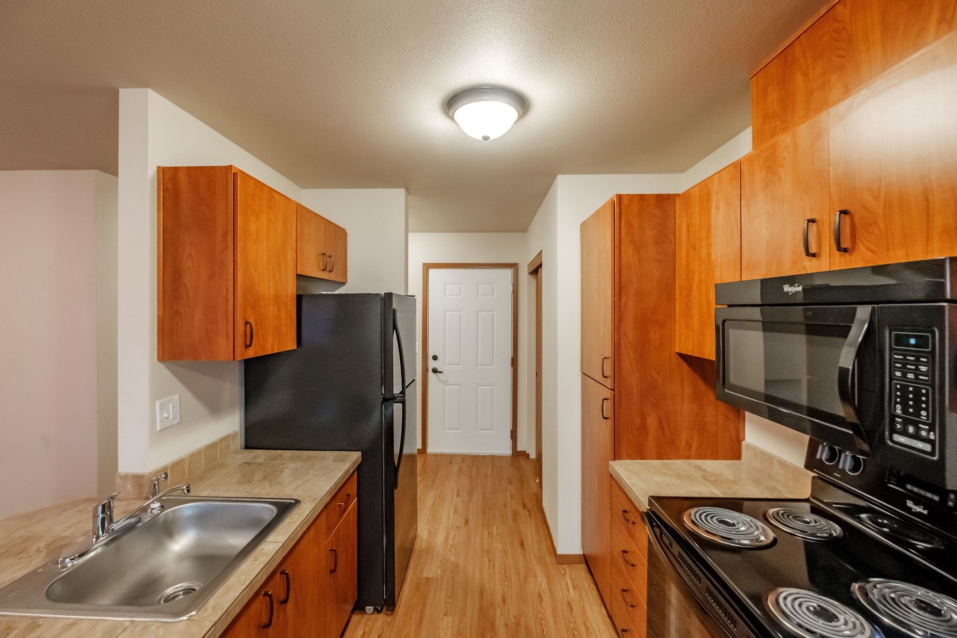 Lafayette Place Apartments in McMinnville, Oregon, near Linfield University – one-bedroom one-bath – kitchen towards door.
