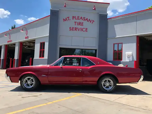 Red vehicle in front of our Mt. Pleasant Tire Location | Modern Mechanics