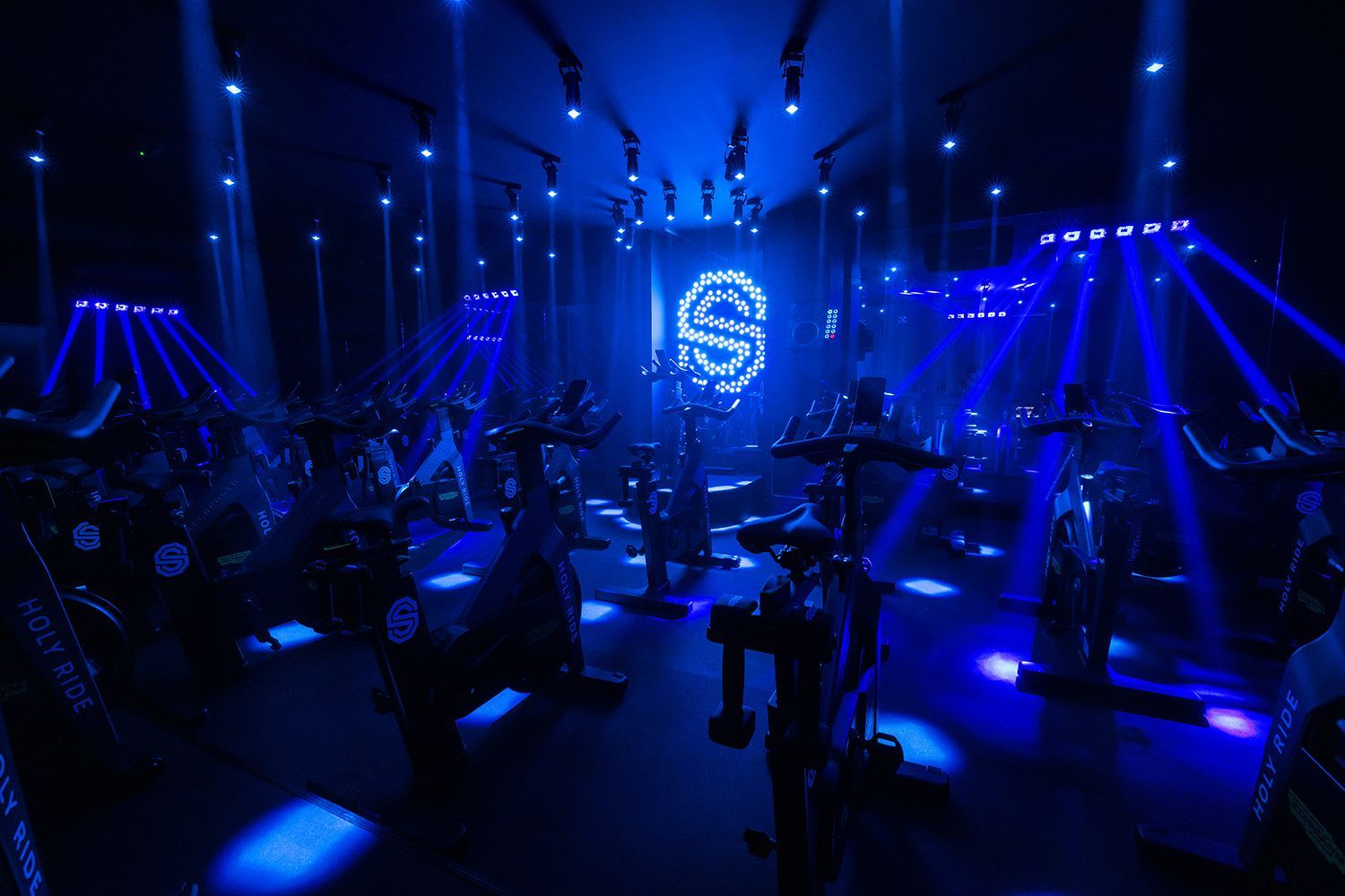 Indoor cycling les met blauwe verlichting en een oplichtend
