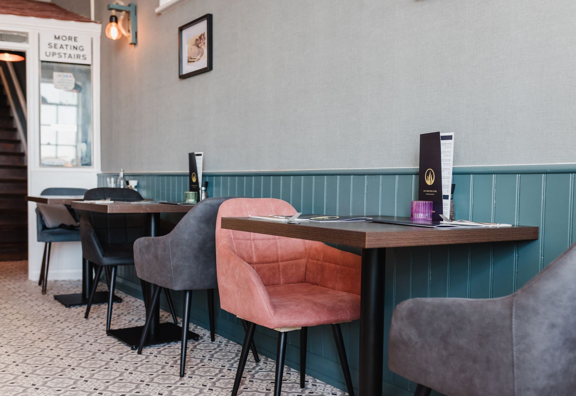 A restaurant with tables and chairs and a sign that says home sweet home