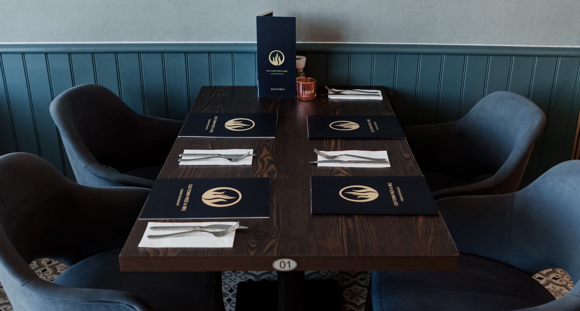 A restaurant table with a menu on top of it
