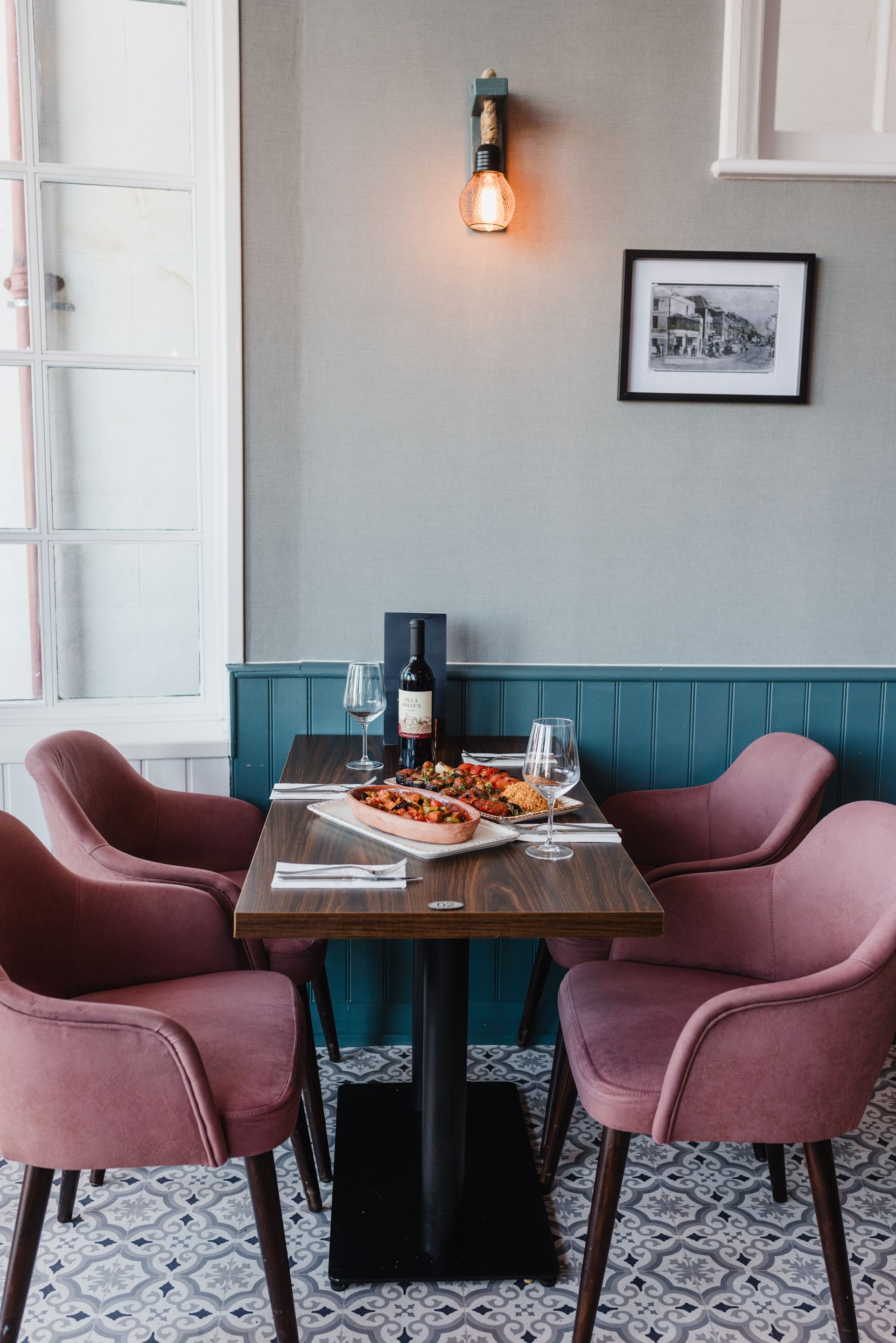 A table in a restaurant with a bottle of wine on it