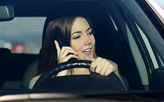 Making a phone call while driving - Insurance agency in Stoughton, MA