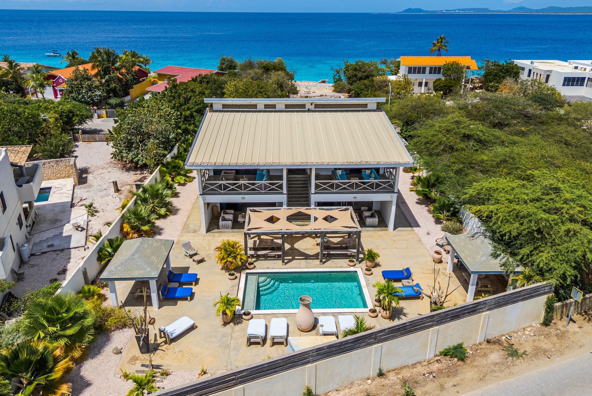 A man and a woman are sitting on a porch reading books.
