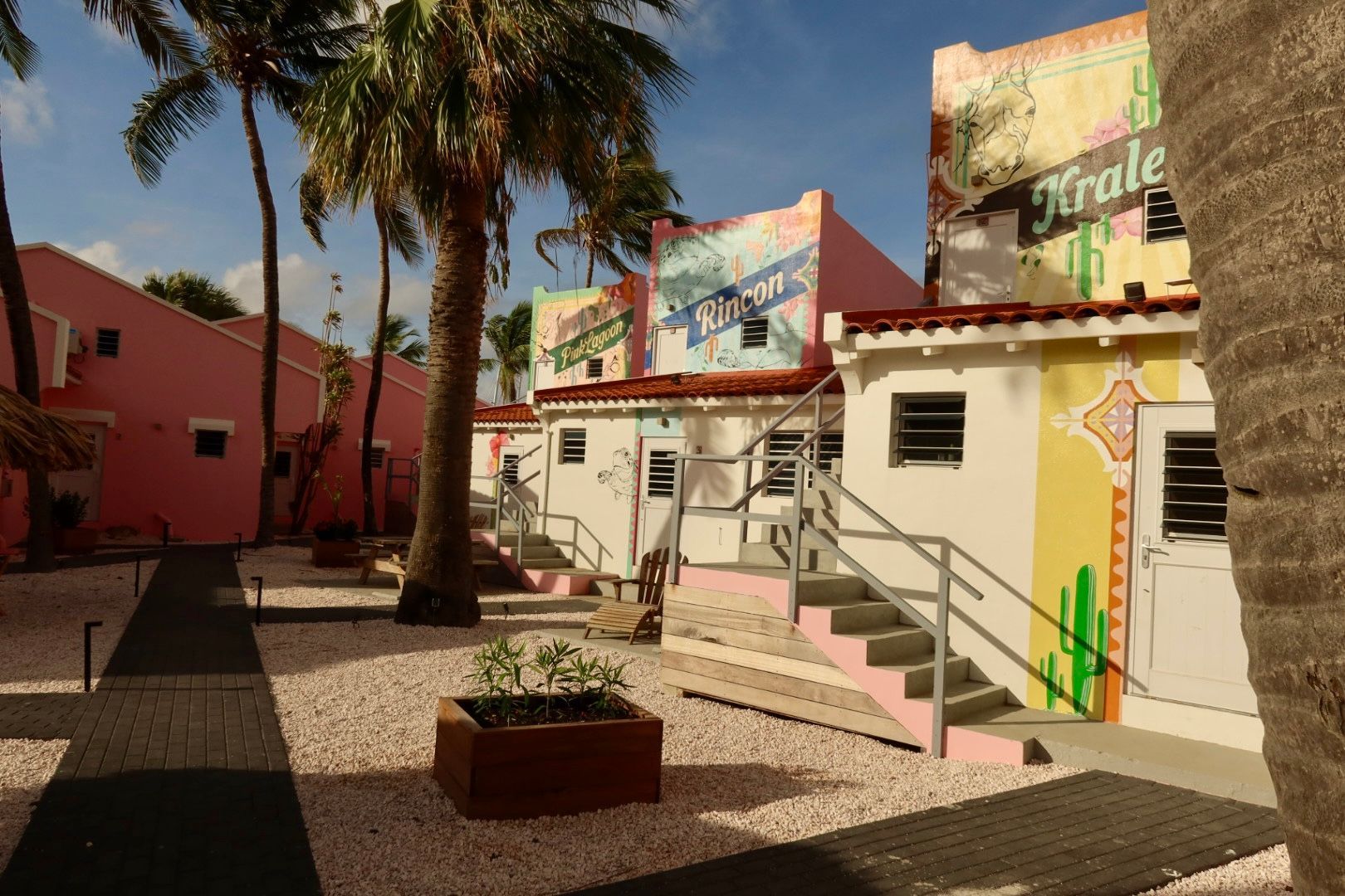 A man and a woman are sitting on a porch reading books.