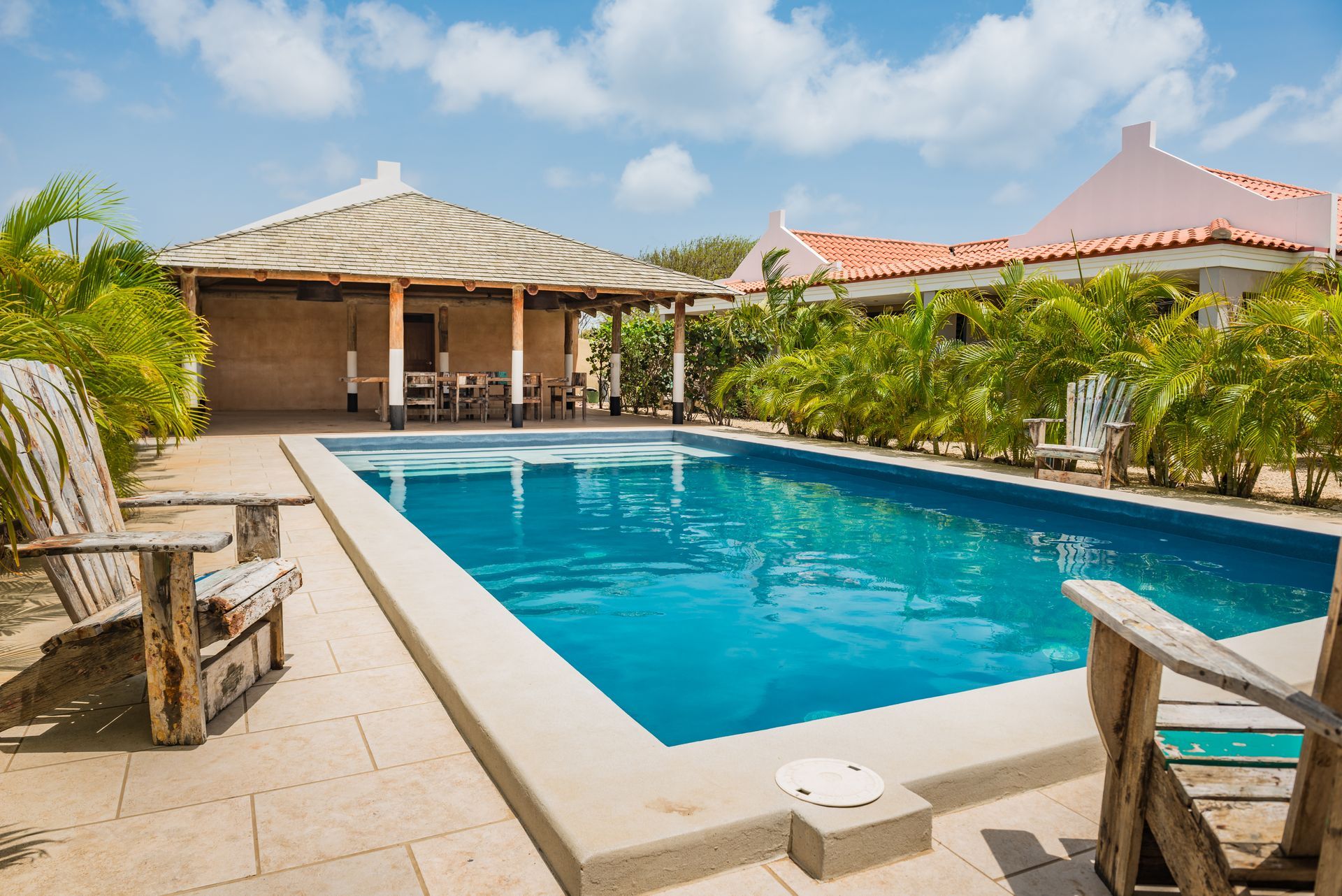 A young boy is swimming in a pool with an inflatable ring.
