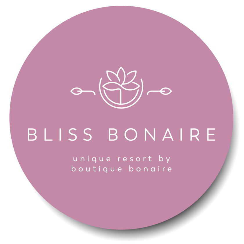 A purple circle with the words coming soon bliss bonaire on it