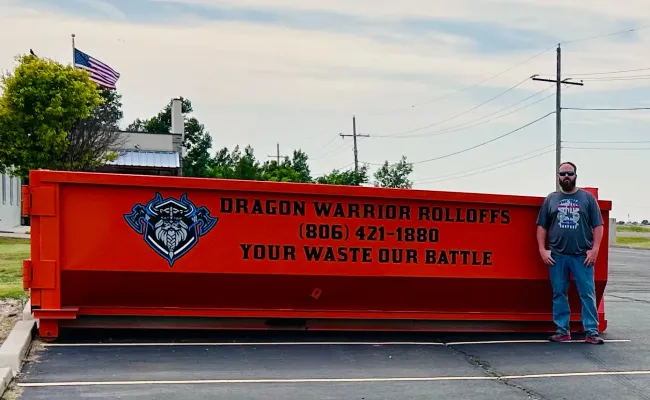 A dumpster with a phone number on it