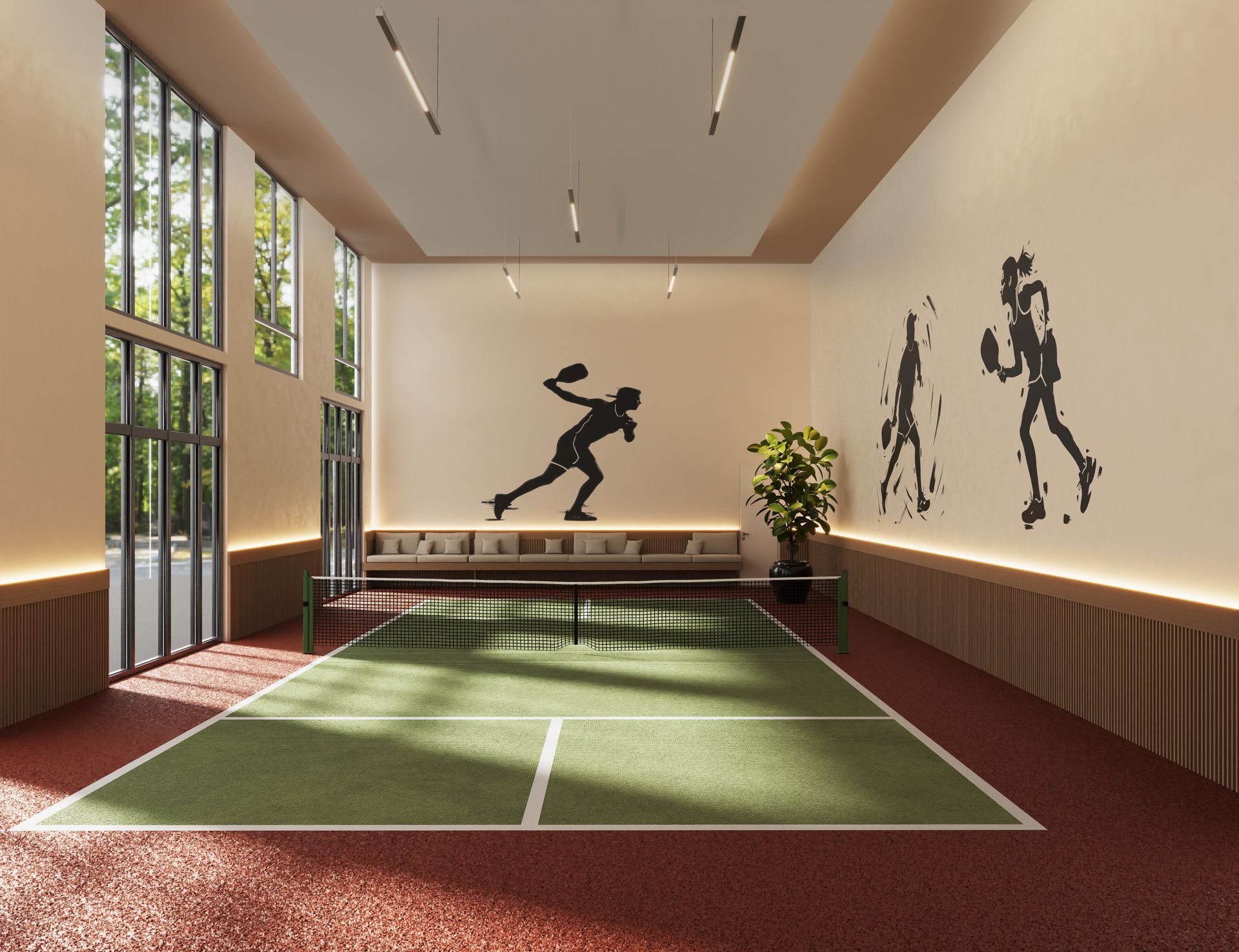 Indoor pickleball court with sports-themed wall art, large windows, and seating. Red and green color scheme.