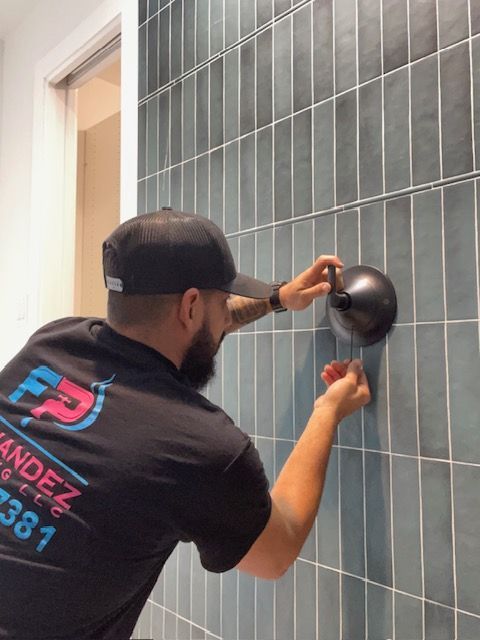 A man wearing a black shirt that says fp on it