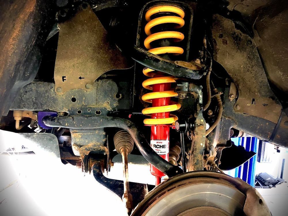 A Close Up of a Shock Absorber on a Car — AWS Mechanical in Stuart Park, NT
