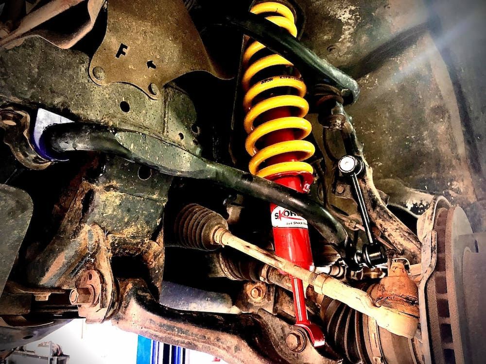 A Close Up of a Shock Absorber on the Underside of a Car — AWS Mechanical in Stuart Park, NT
