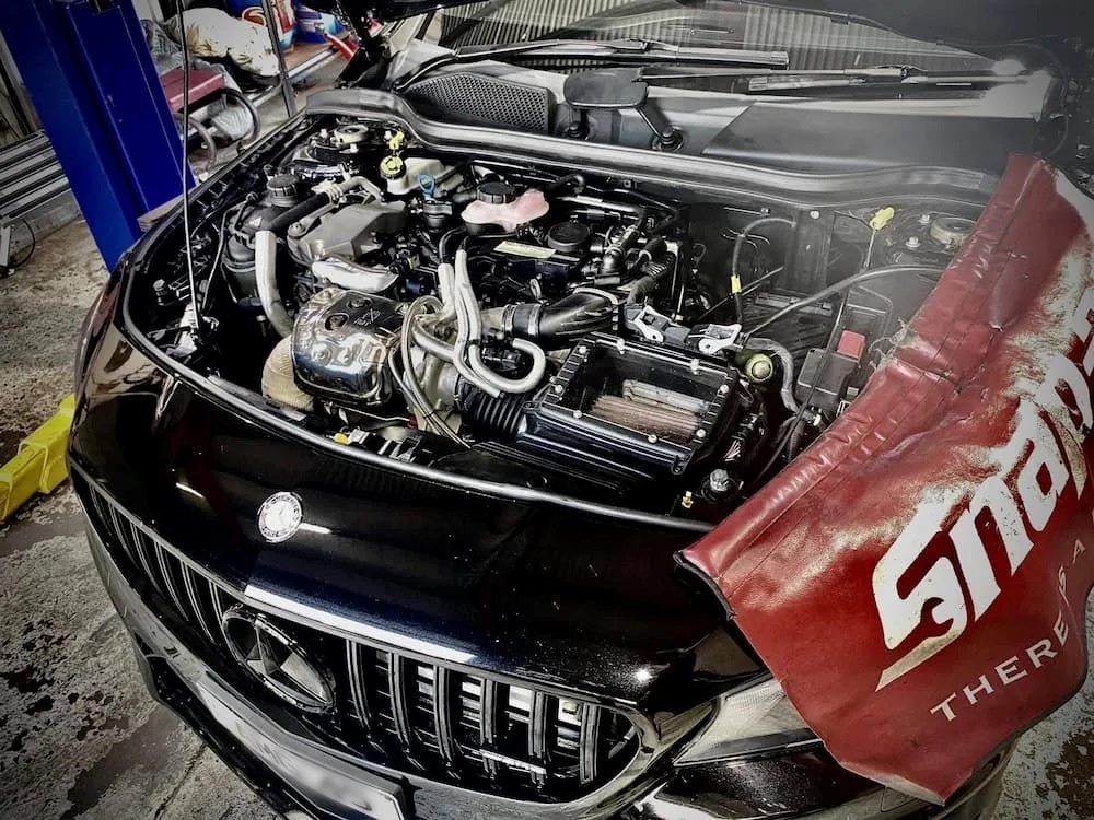 A Black Car With the Hood Open and a Snap on Towel on the Hood — AWS Mechanical in Stuart Park, NT