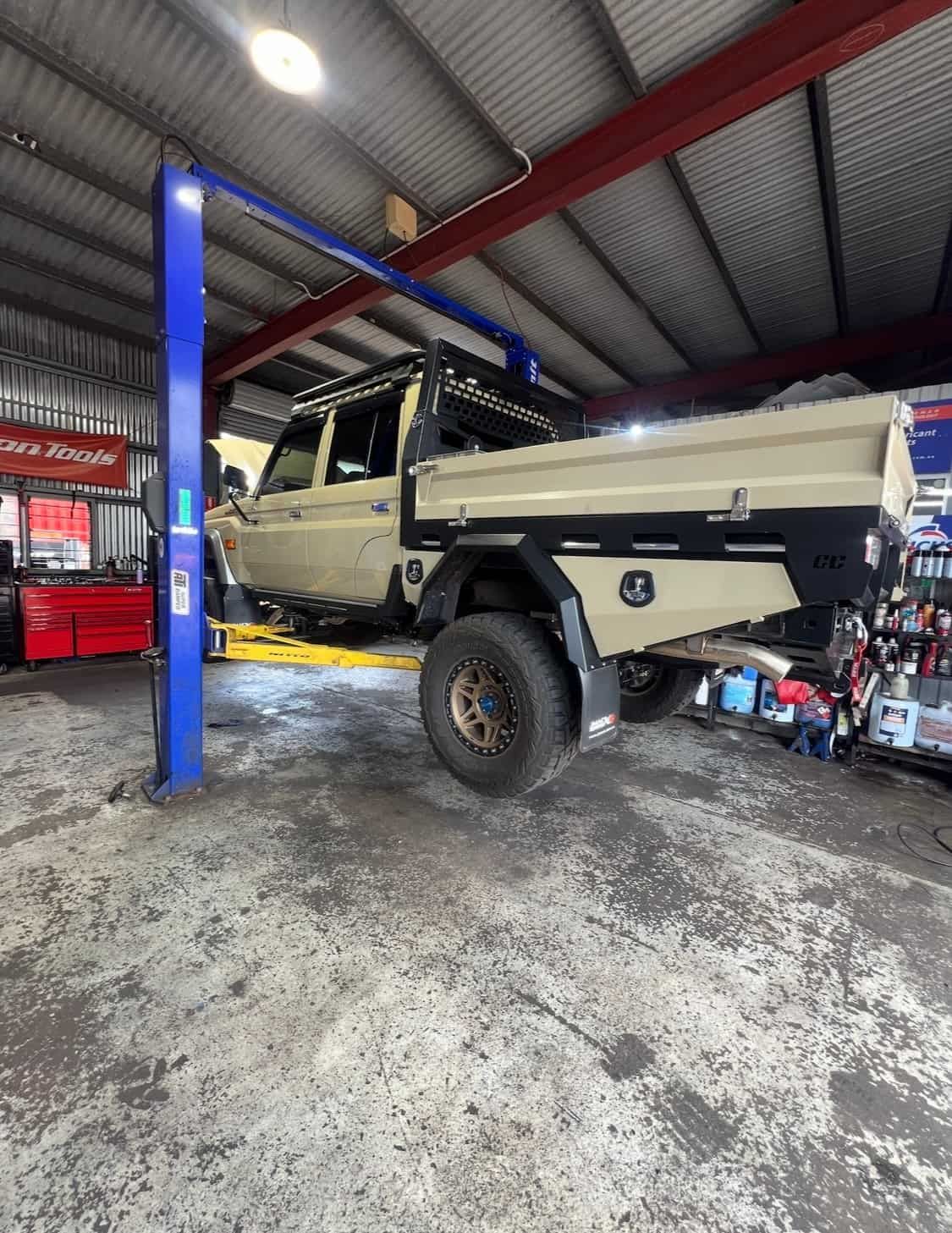 A Truck is Sitting on a Lift in a Garage — AWS Mechanical in Stuart Park, NT