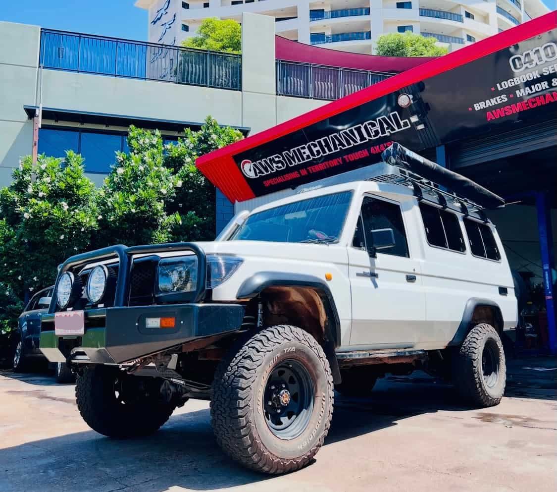 A White Suv is Parked in Front of a Building — AWS Mechanical in Stuart Park, NT