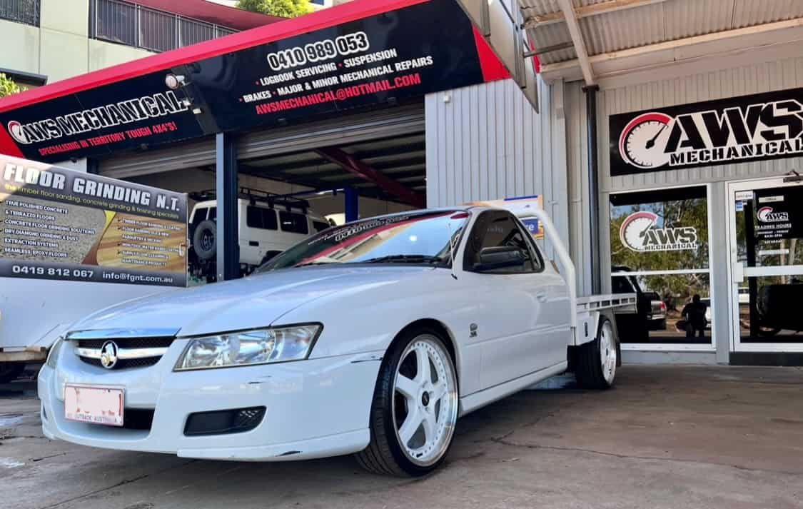 A White Car is Parked in Front of a Car Dealership — AWS Mechanical in Stuart Park, NT