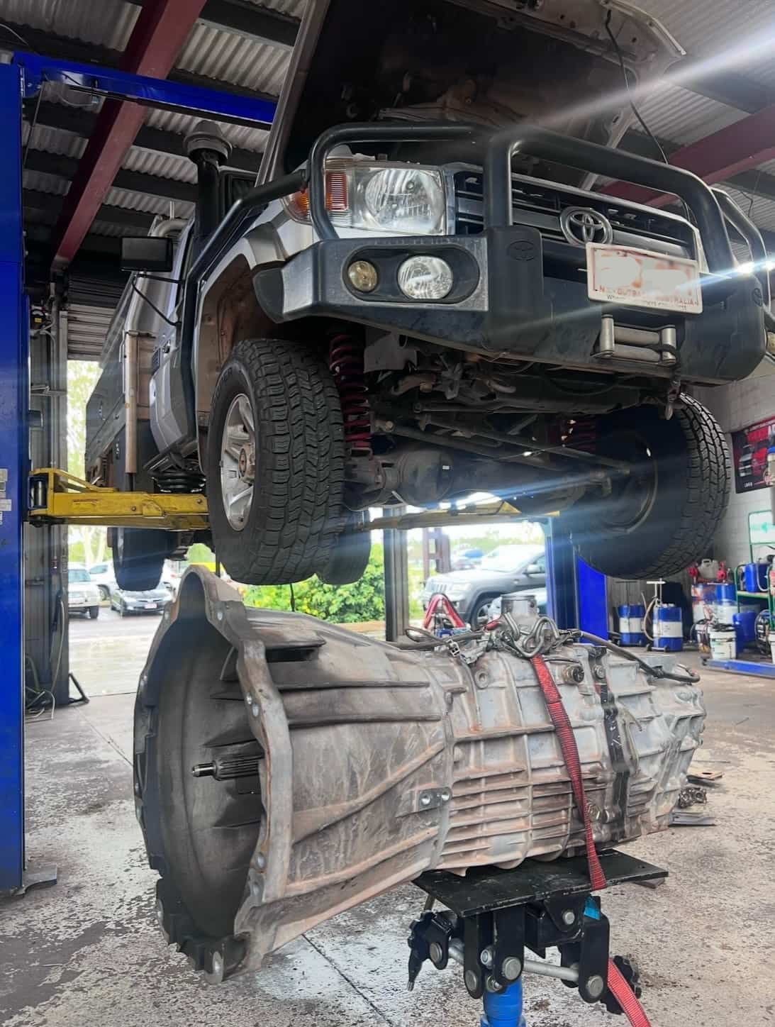 A Truck is Sitting on a Lift in a Garage  — AWS Mechanical in Stuart Park, NT