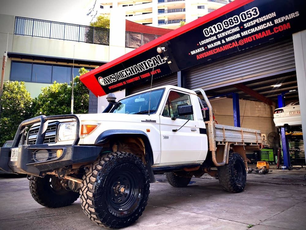A White Truck is Parked in Front of a Garage — AWS Mechanical in Stuart Park, NT