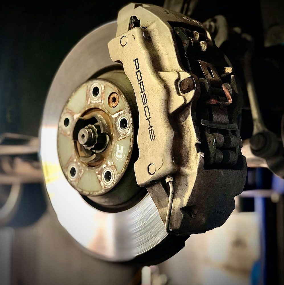 A Close Up of a Porsche Brake on a Car — AWS Mechanical in Stuart Park, NT
