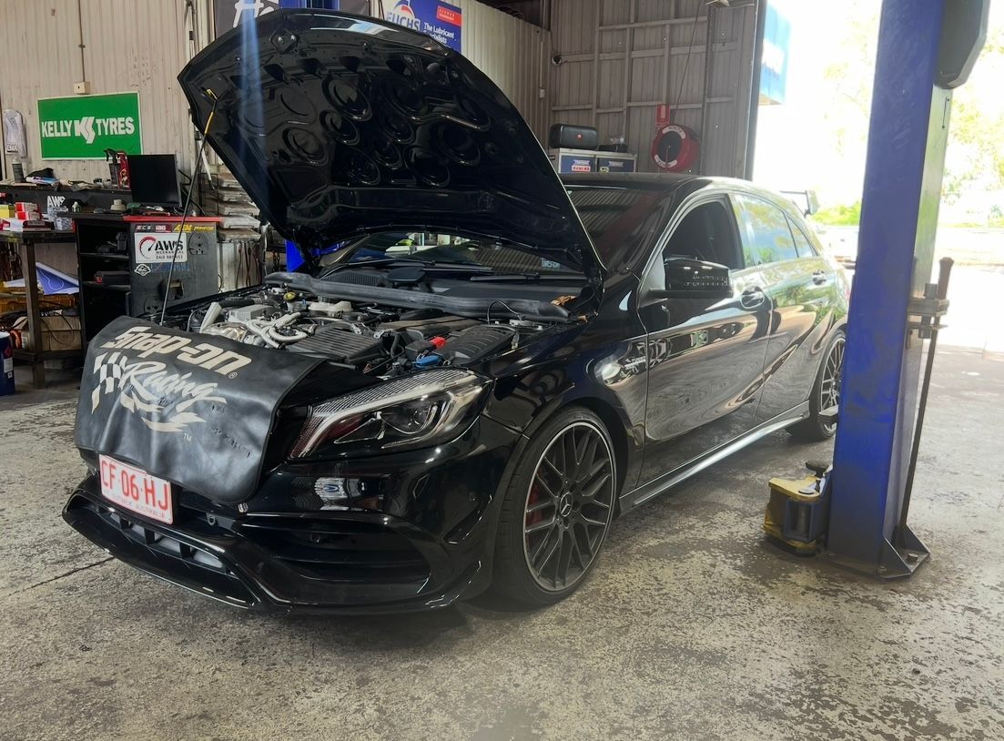 A Black Car With the Hood Up is Being Worked on in a Garage — AWS Mechanical in Stuart Park, NT