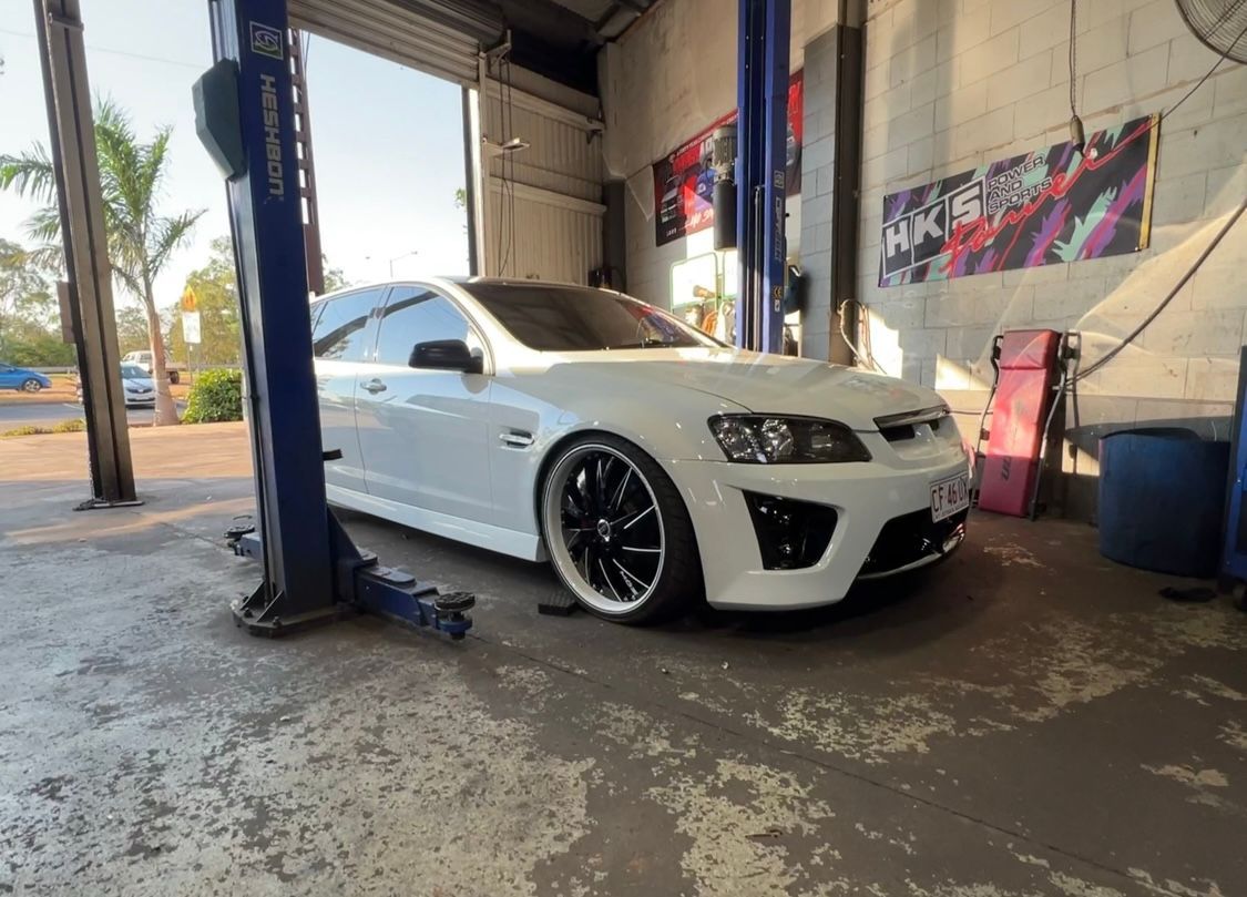 A White holden is parked in a mechanics garage — AWS Mechanical in Stuart Park, NT