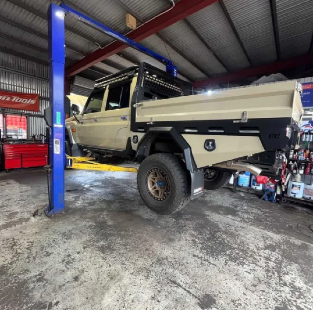 A truck is sitting on a lift in a garage — AWS Mechanical in Stuart Park, NT