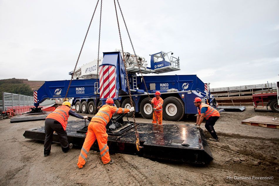 Un gruppo di operai edili sta lavorando su un grande pezzo di attrezzatura.
