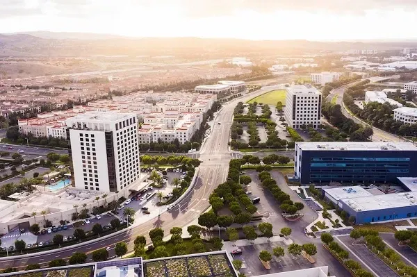 An aerial view of a city with lots of buildings and trees.
